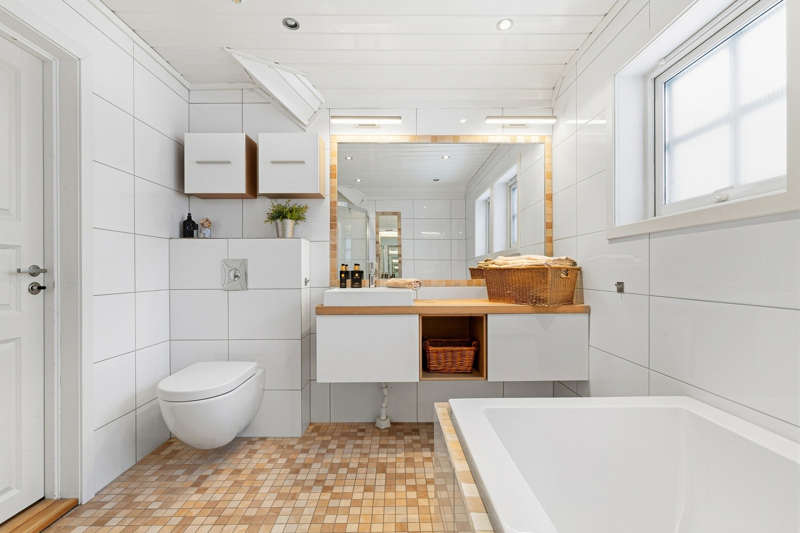 Badet er utstyrt med innfliset badekar og en separat dusjplass med skyvedør. Galleribilde