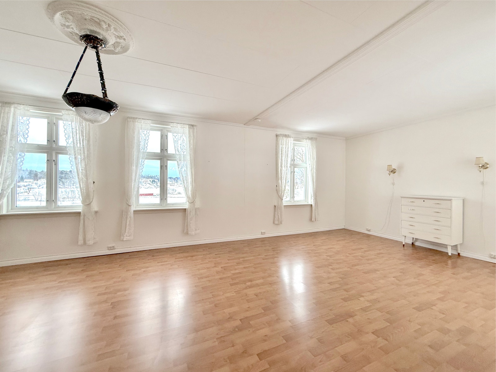 Romslig stue med store vinduer, profilerte detaljer og lys atmosfære Galleribilde