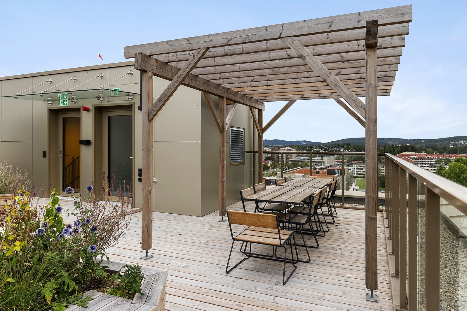 Felles takterrasse på taket til Hus E med pergola og hyggelig beplantning. Galleribilde