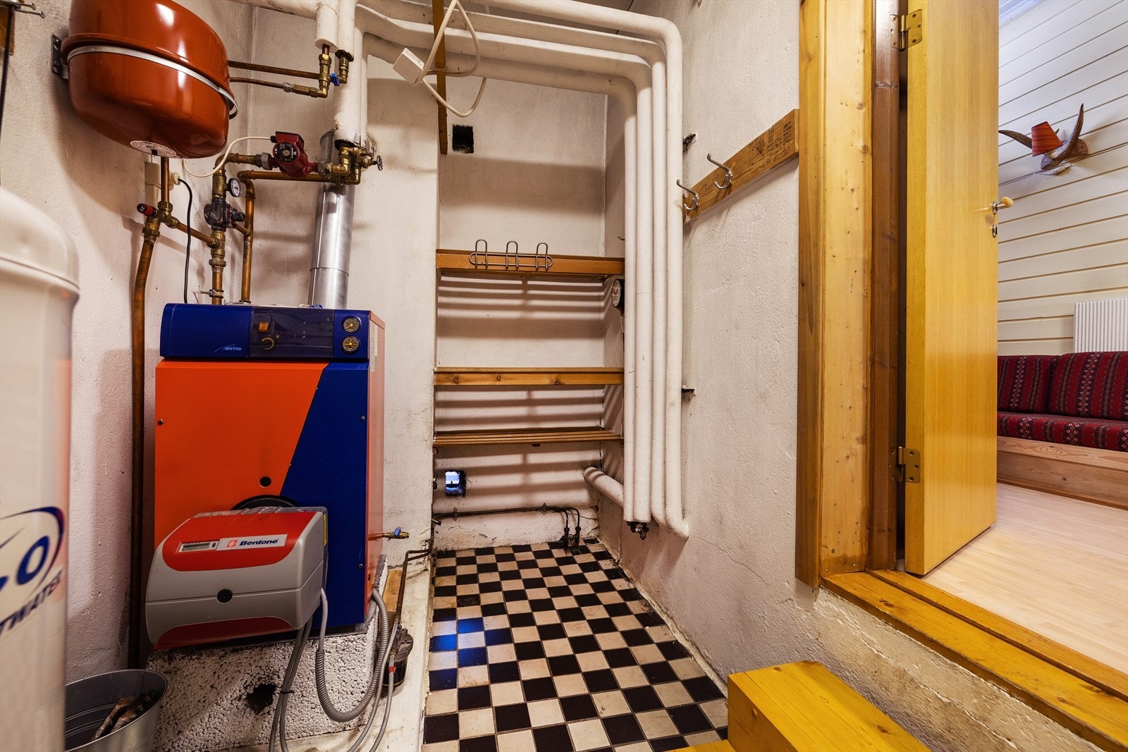 Teknisk rom med varmtvannsbereder og det utfasede oljefyranlegget. Galleribilde