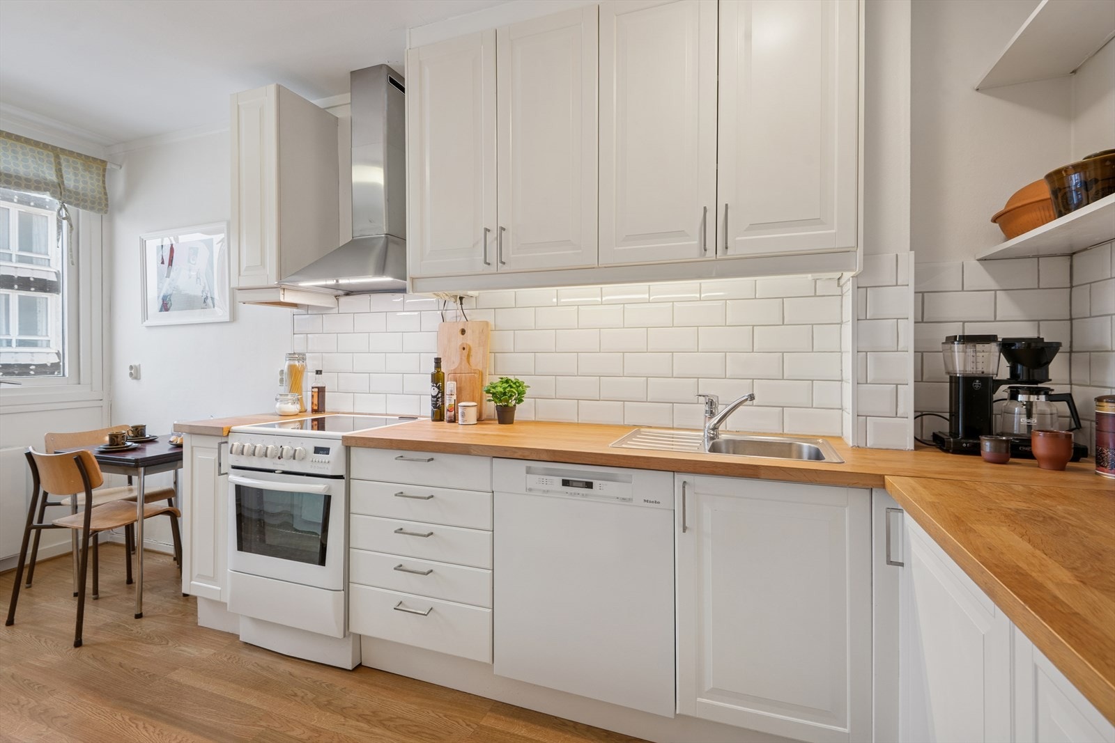 Innredning med profilerte fronter og benkeplate av spon med en tykk, heltre finert overflate, samt oppvaskkum. Galleribilde