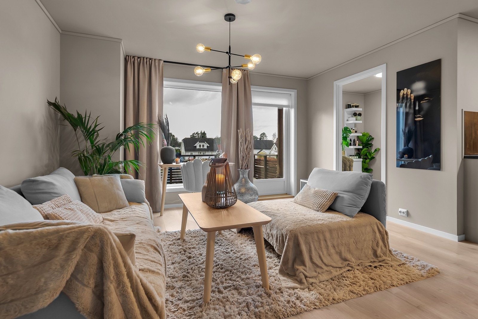 Leiligheten har en lys og luftig stue med store vindusflater som slipper inn rikelig med naturlig lys Galleribilde