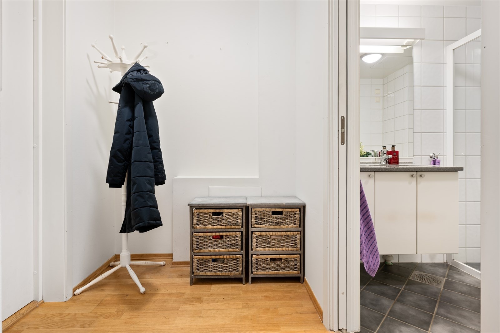 Parkettgulv og malte glatte vegger gir et moderne uttrykk i entréen. Galleribilde