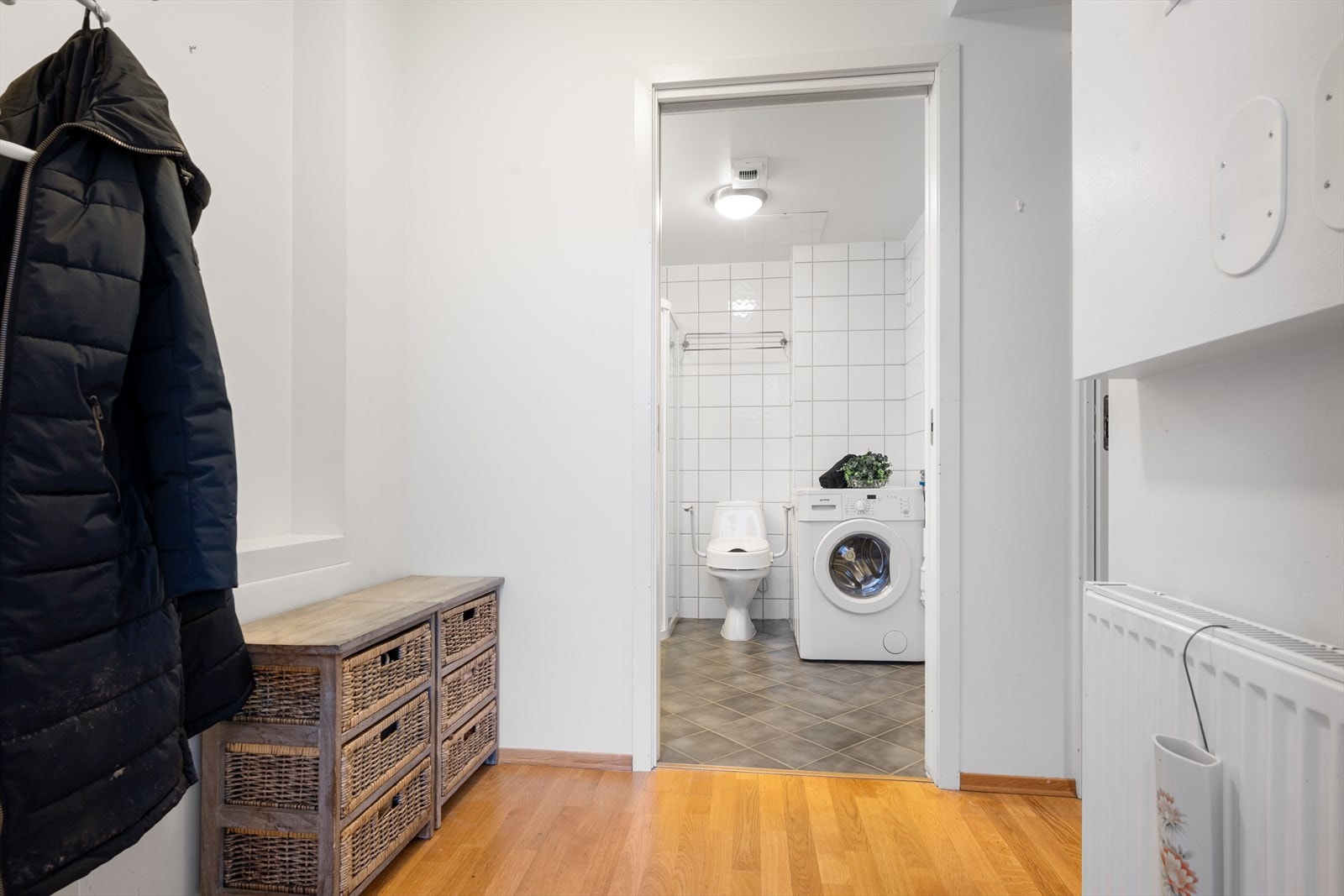 Flislagt bad med opplegg for vaskemaskin og balansert ventilasjon sikrer praktisk bruk. Galleribilde