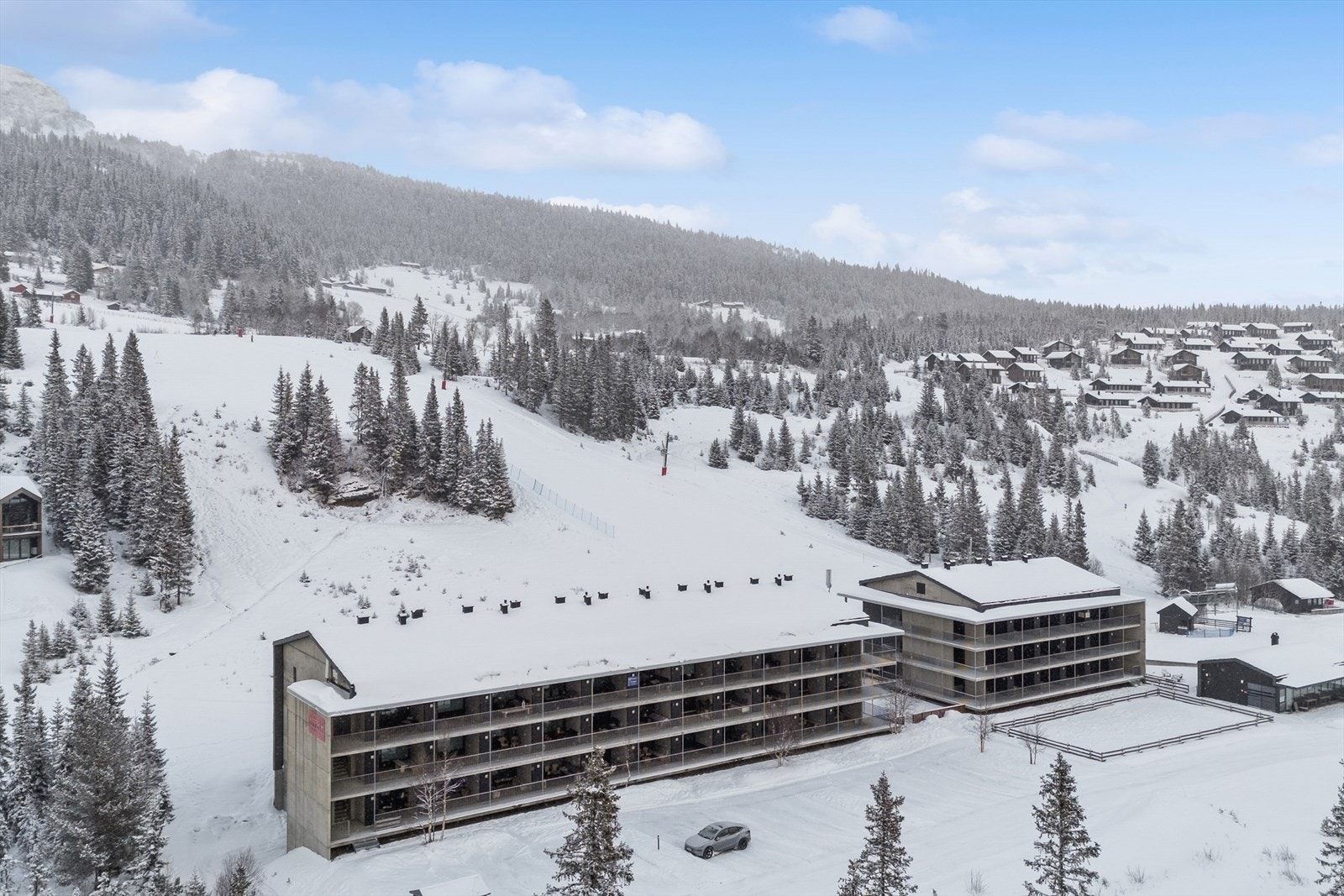 Bygget har en robust fasade kledd med skifer, fasadeplater og treverk. Galleribilde