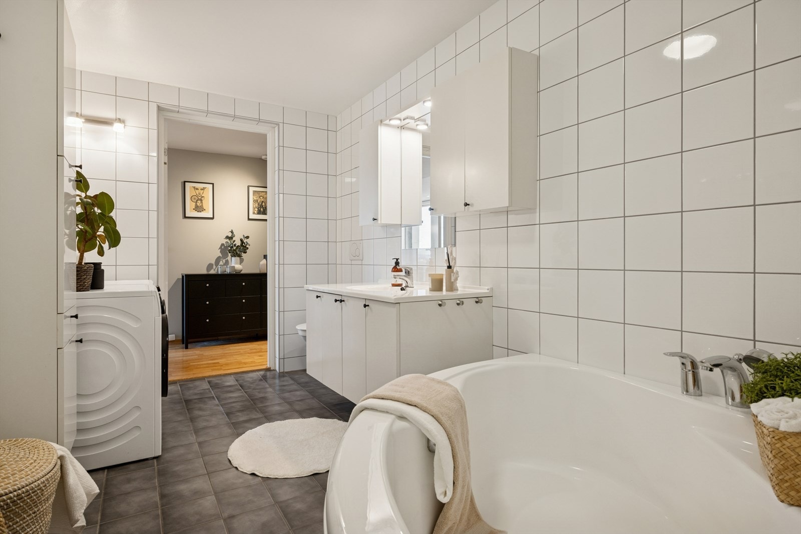 Baderommet er innredet med servantskap, klosett med innebygd sisterne, badekar og innfellbar dusjvegg. Opplegg for vaskemaskin. Galleribilde