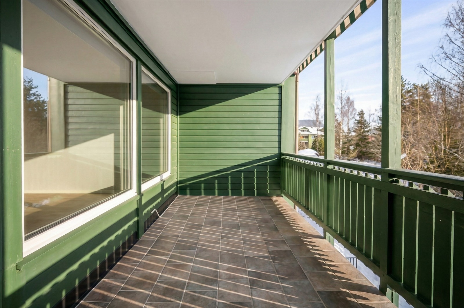 Balkongen har flislagt gulv og god plass for utemøbler. Galleribilde