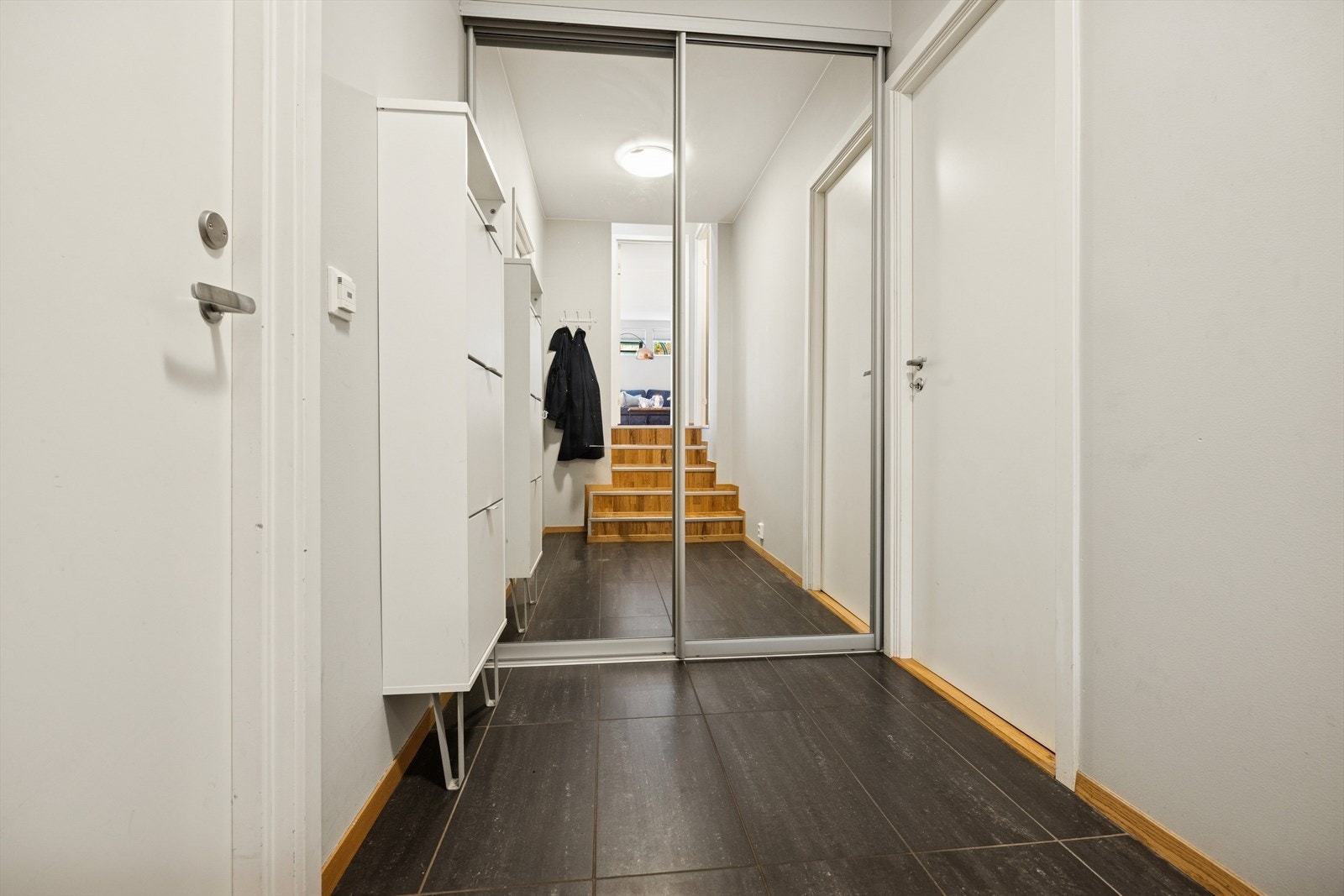 Inngang til underetasjen via garasjen med praktisk sko-og skapplass. Det er også inngang til bod. Galleribilde