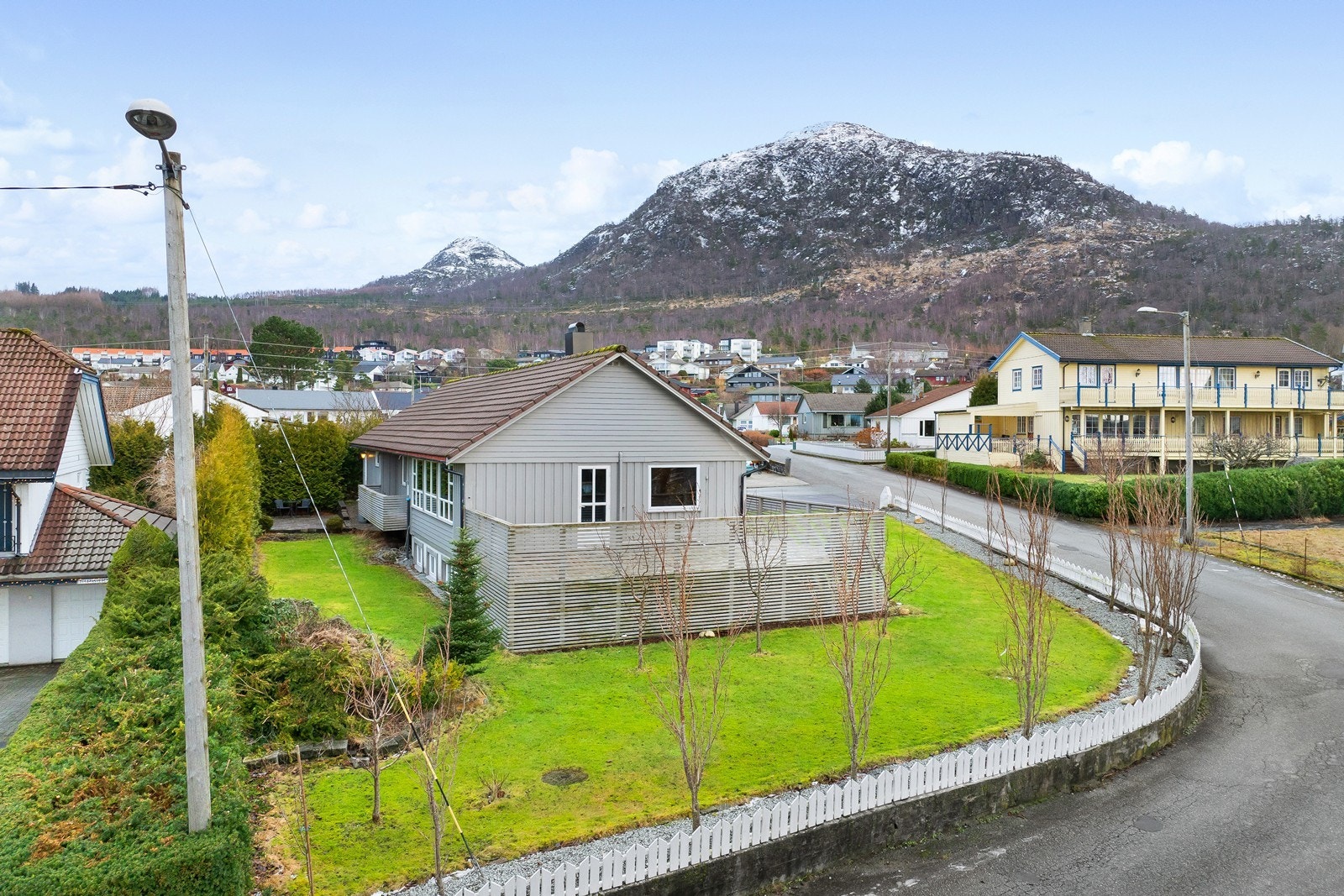 Lettstelt flott hage med harmonisk kombinasjon av belegningsstein, plen og busker. Galleribilde