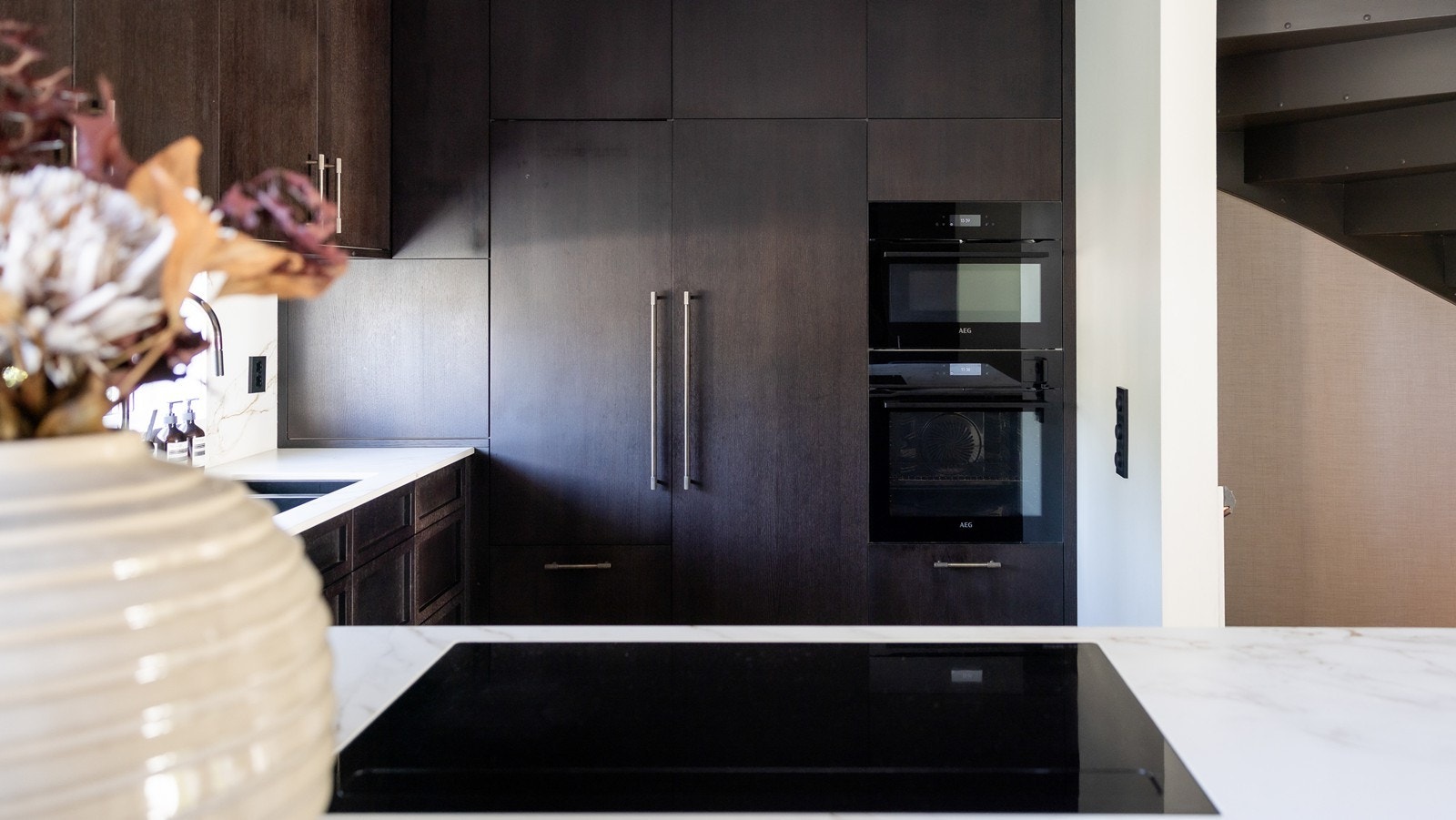 Kjøkken- og kaffemaskiner integrert i høyskap. Dampovn og kombiovn, platetopp med integrert ventilator med avtrekk ut Galleribilde