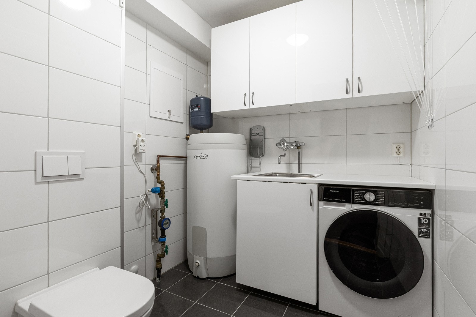 1. etasje: Eget vaskerom med dør inn fra entrèen. Her er det i tillegg et ekstra toalett og utslagsvask Galleribilde