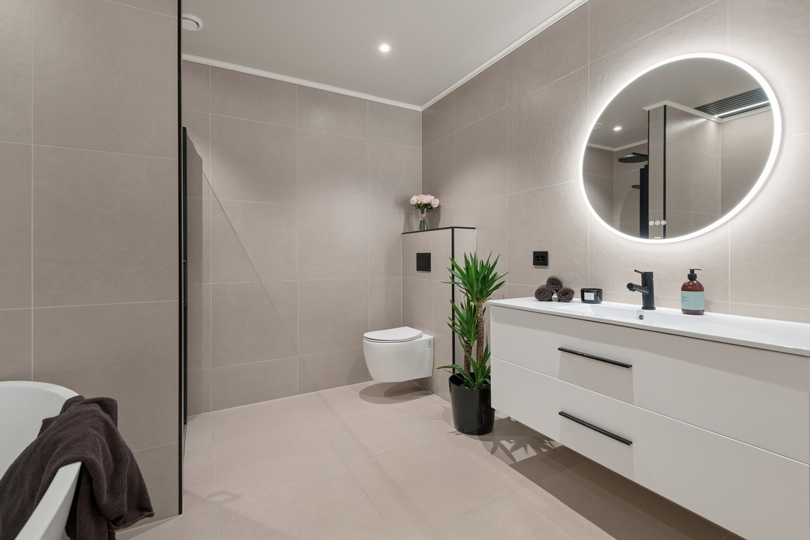 Lekkert baderom i moderne og tidsriktig utførelse med keramiske fliser på vegger og gulv. Galleribilde