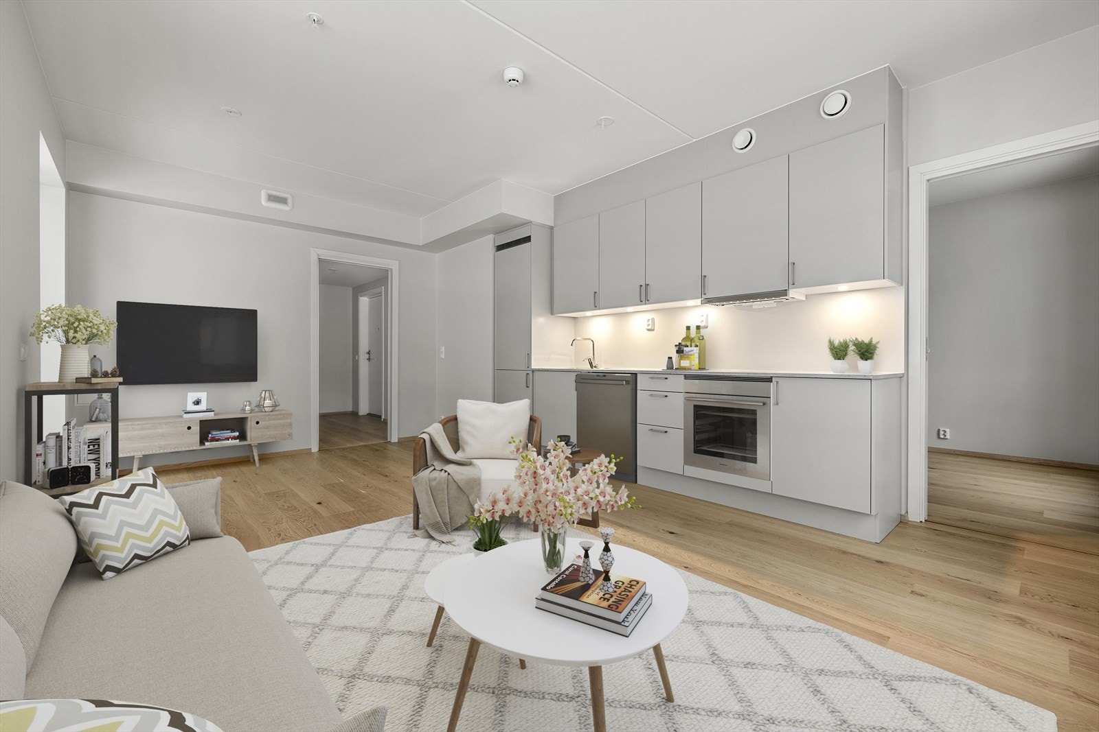 Den åpne løsningen mellom stue og kjøkken skaper en sosial og fleksibel sone. Bildet er digitalt stylet. Galleribilde