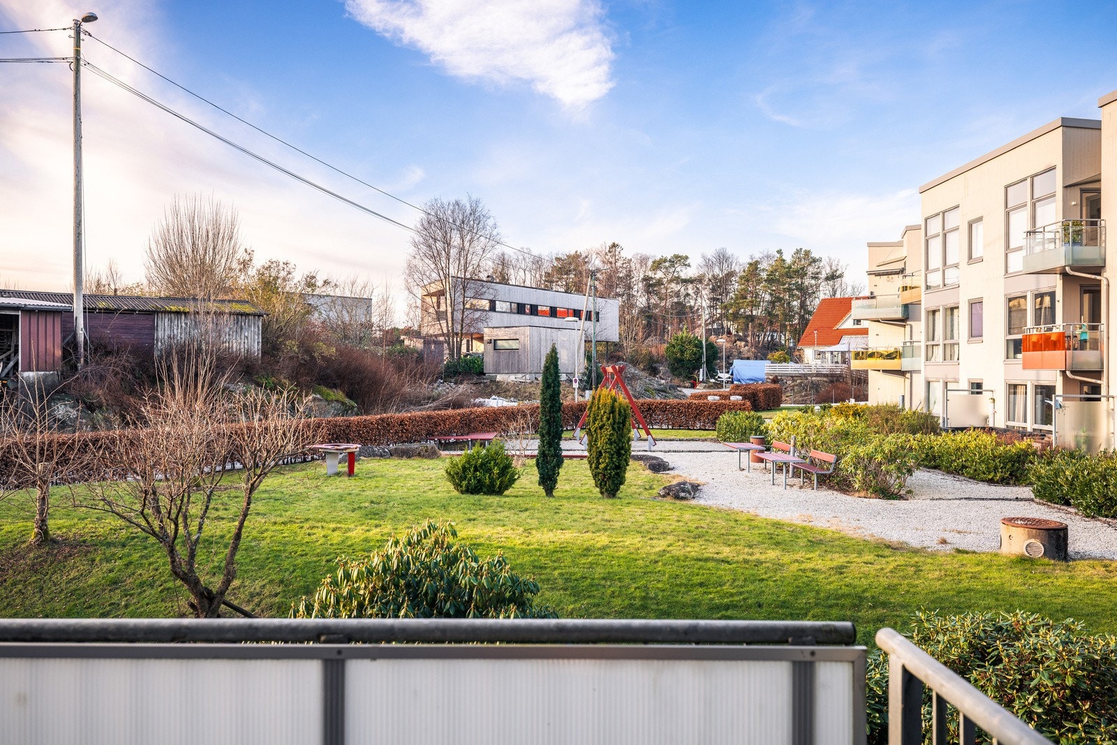 Hyggelig utsyn fra leilighetens stue og altan ut mot fellesarealer. Galleribilde