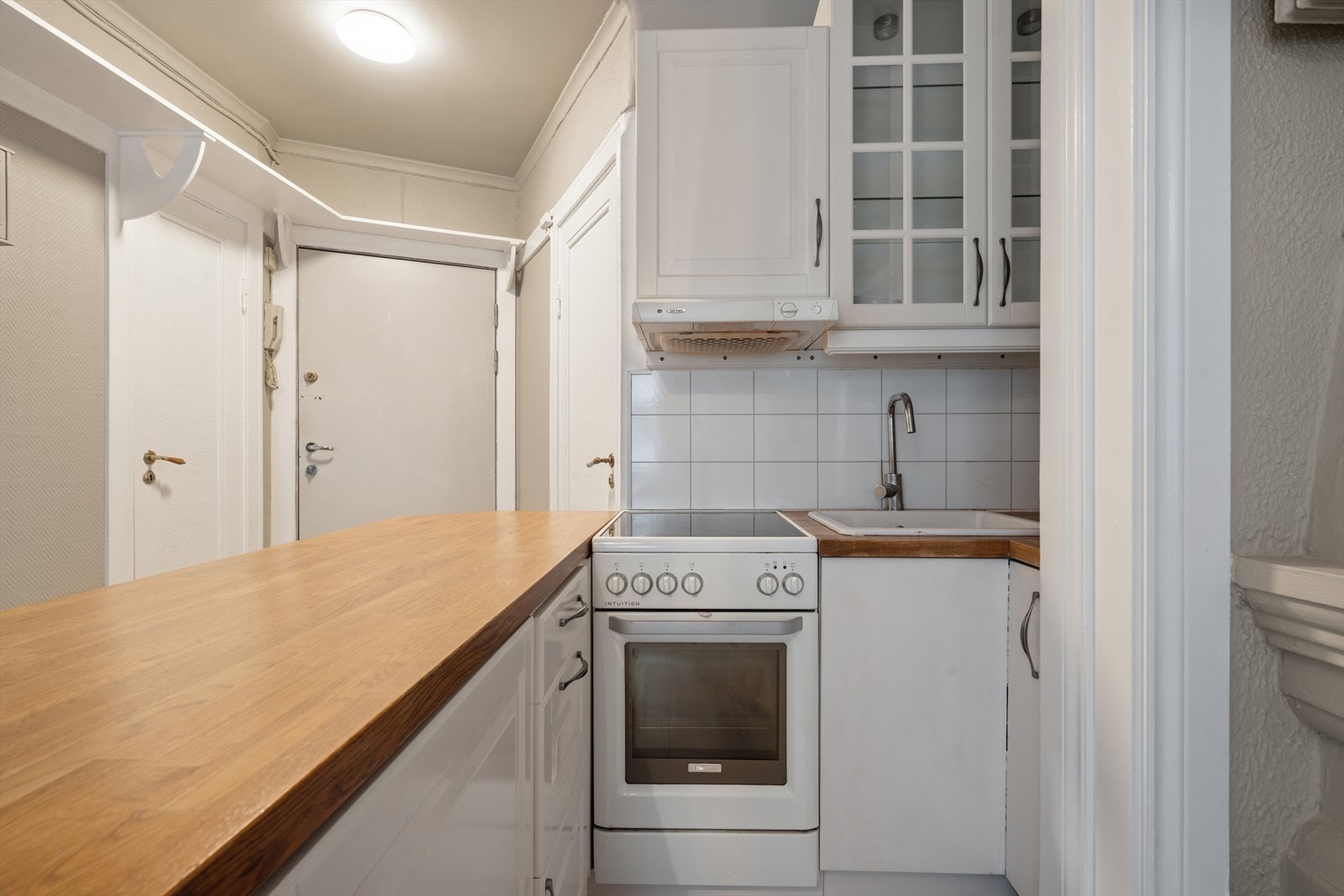 Plater i laminat over benkeskap. Innredningen er eldre med noe bruksslitasje. Galleribilde