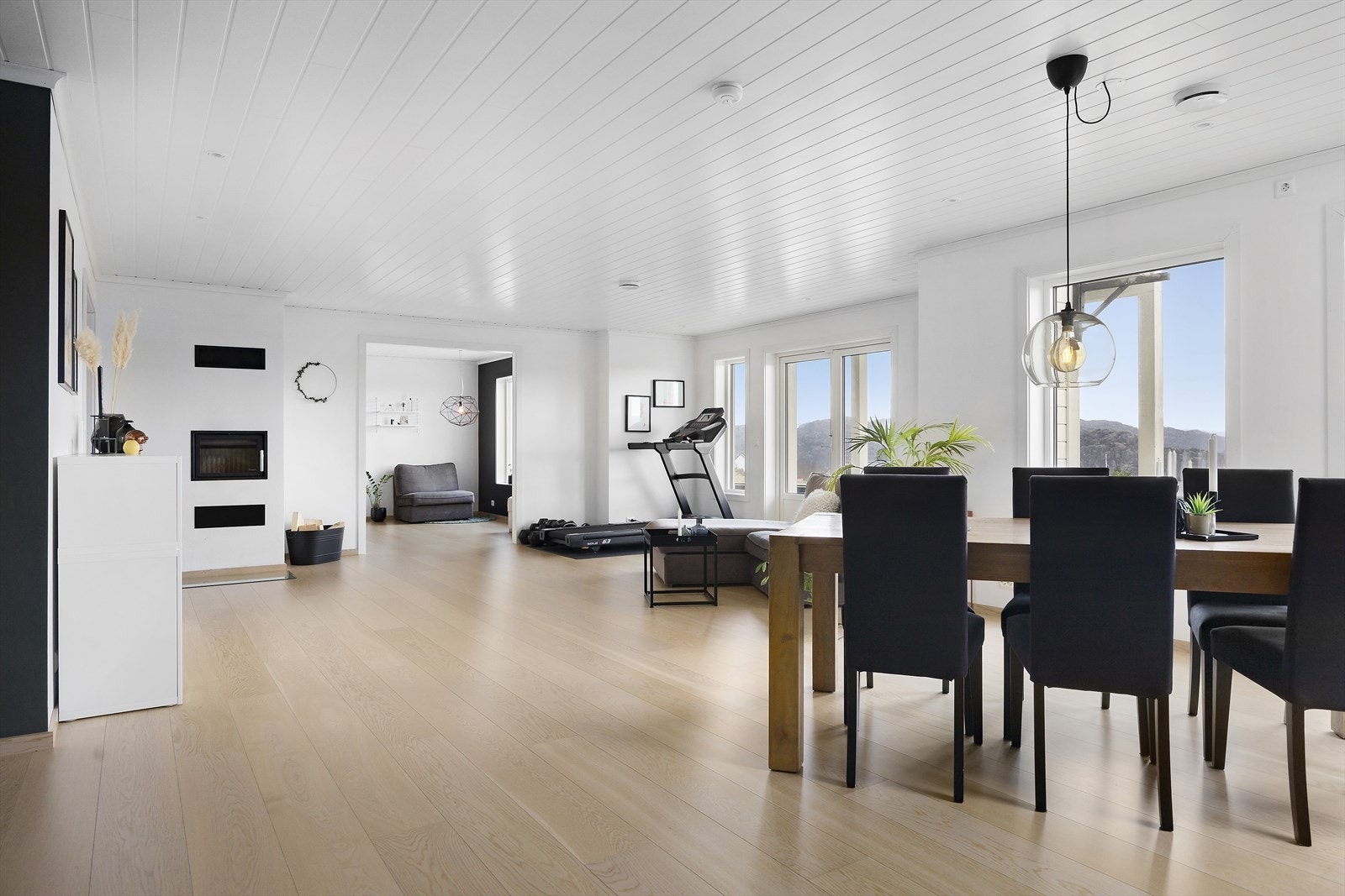 Med en kombinasjon av store vindusflater, varmepumpe og vedovn fremstår denne stuen som både lys, luftig og lun. Galleribilde