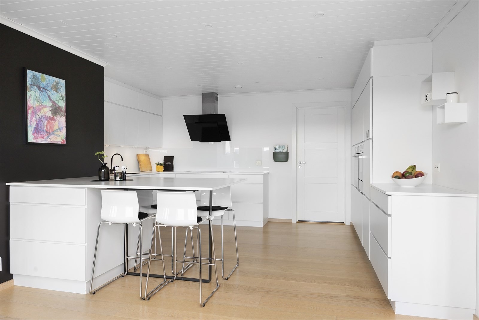 Det lyse og moderne kjøkkenet har slette fronter og integrerte hvitevarer som gir et stilrent og helhetlig preg. Her er det god skap- og arbeidsplass, samt en praktisk kjøkkenøy som både har oppbevaringsplass og fungerer som et koselig spiseområde. Galleribilde