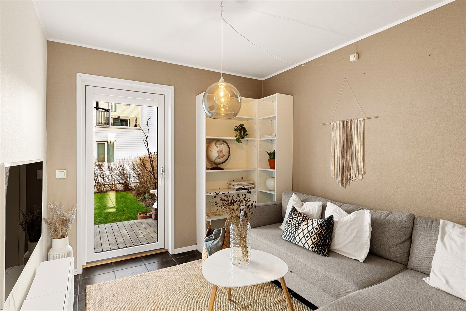 Kjekk og praktisk kjellerstue med utgang til den solvendte terrassen og hagen Galleribilde