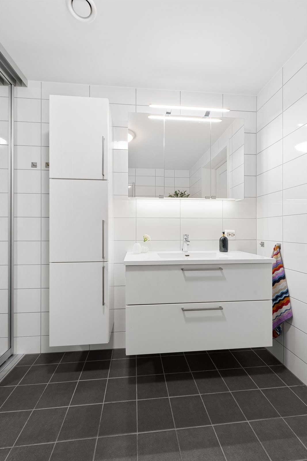 Innredning med nedfelt servant, vegghengt skap, speilskap med overlys og stikkontakter over servant og i speilskap Galleribilde