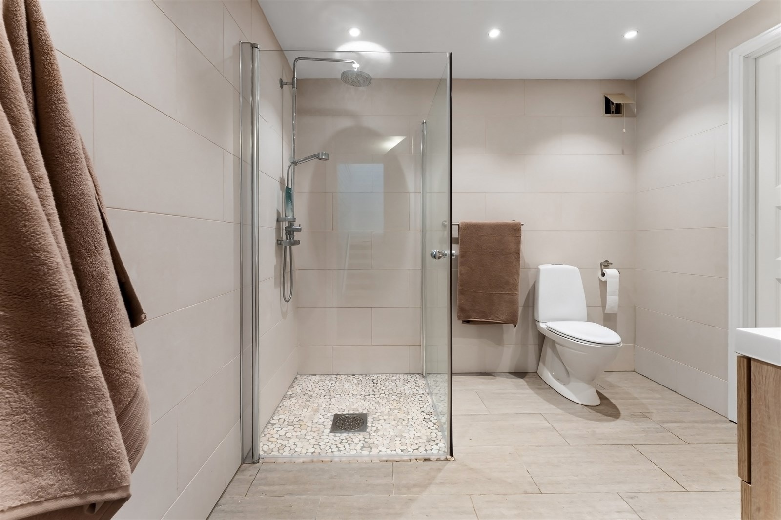 Romslig dusjhjørne med svingbare glassdører. Galleribilde