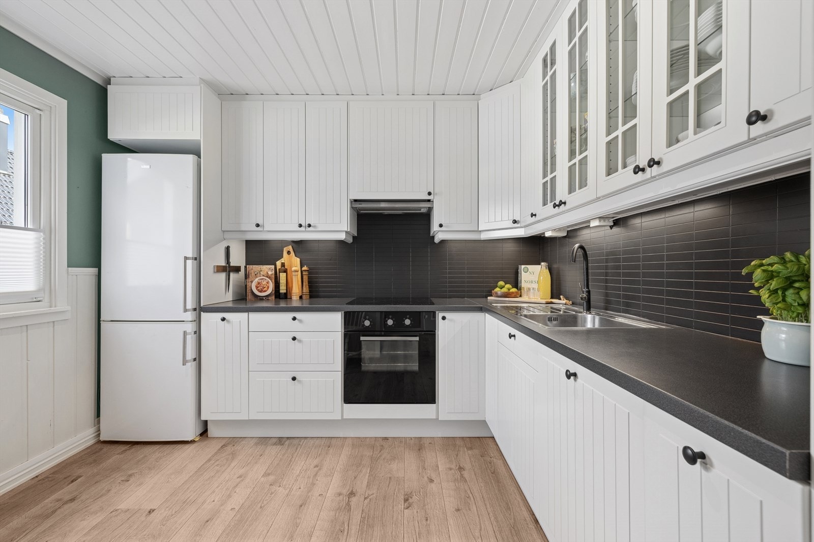 Kjøkkenet er utstyrt med integrert platetopp, komfyr og oppvaskmaskin. Galleribilde