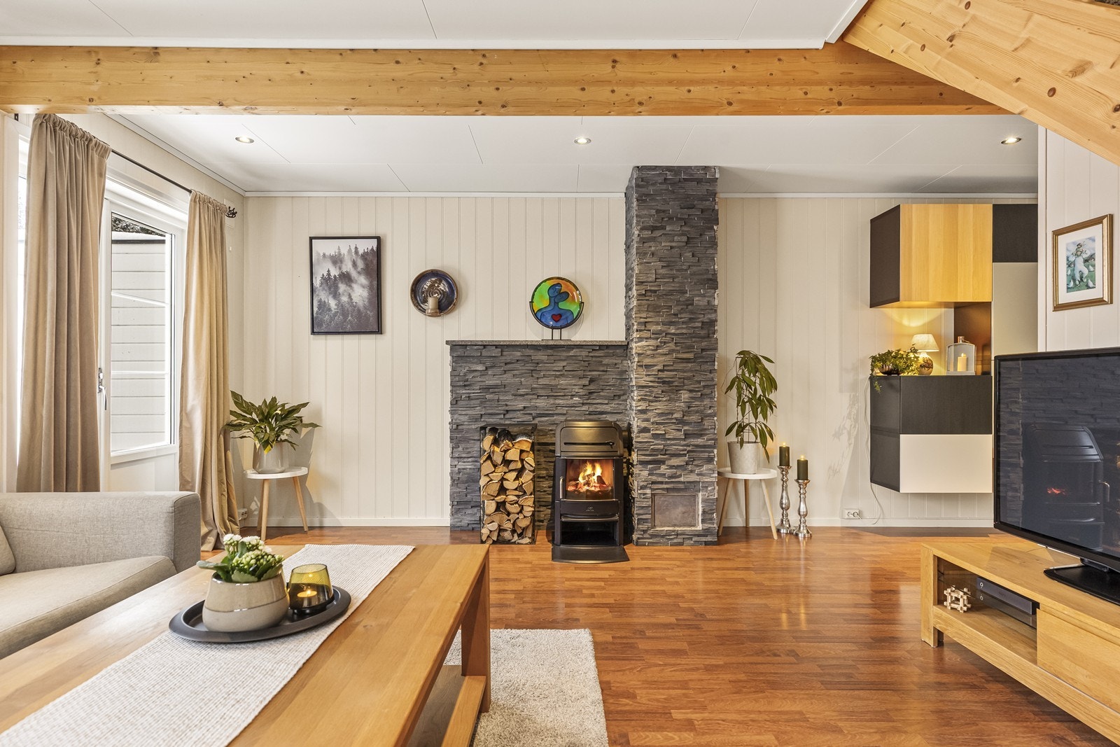 Stuen er romslig og har en sentralt plassert peisovn som gir god varme. Galleribilde