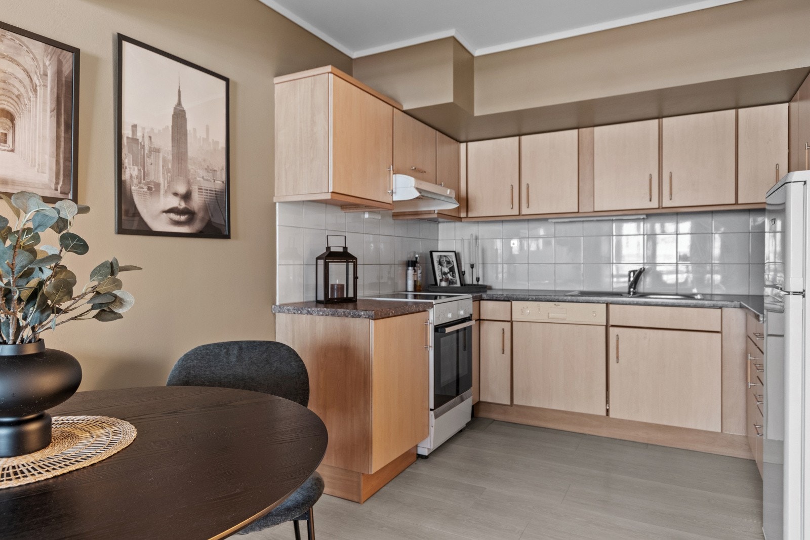 Kjøkken med opplegg for hvitevarer; komfyr, oppvaskmaskin og kombiskap. Galleribilde