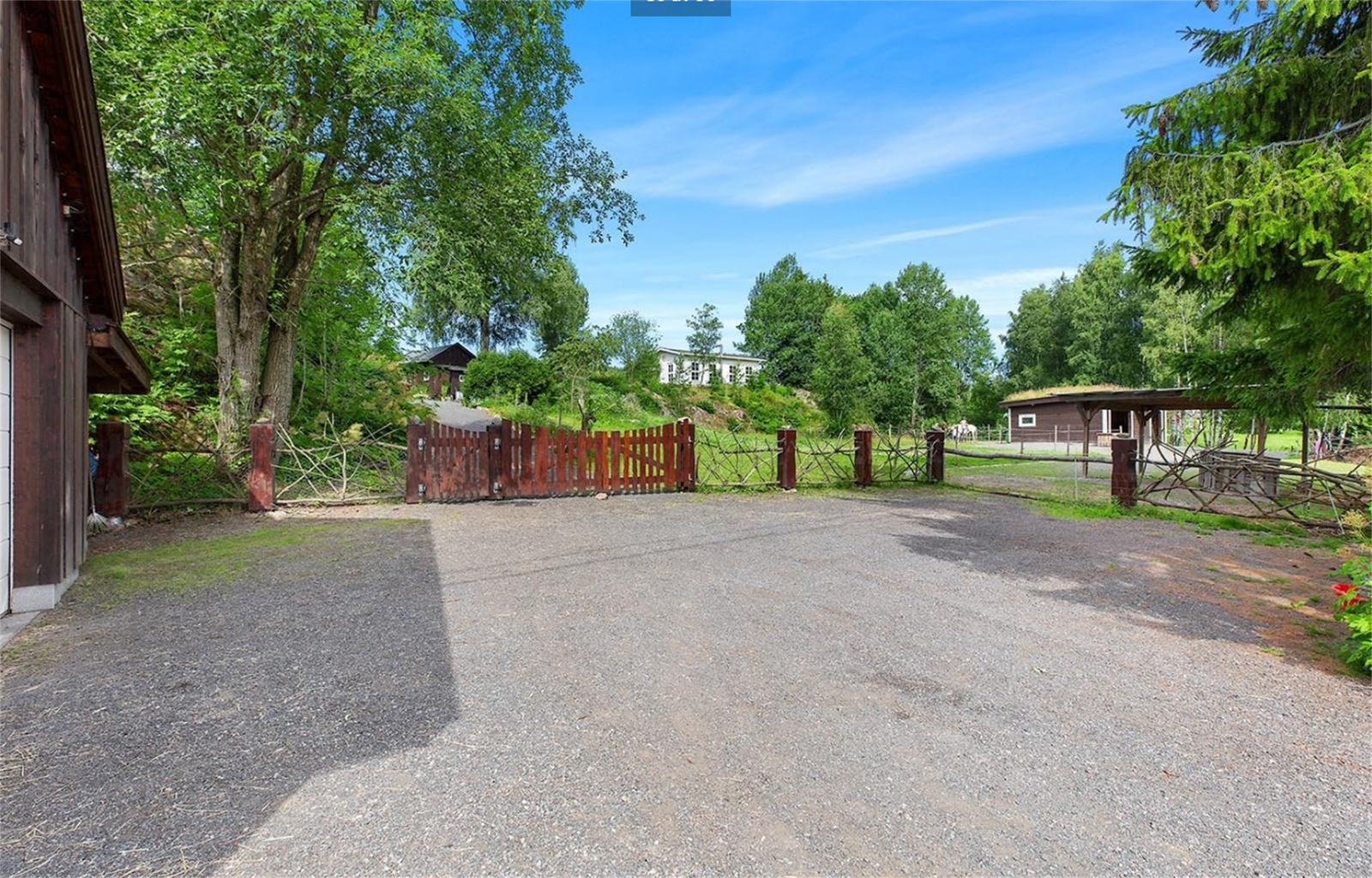 Dobbel garasje og gruset gårdsplass - Tidligere sommerbilde - Avvik kan forekommen da selger har tatt vekk mange trær Galleribilde