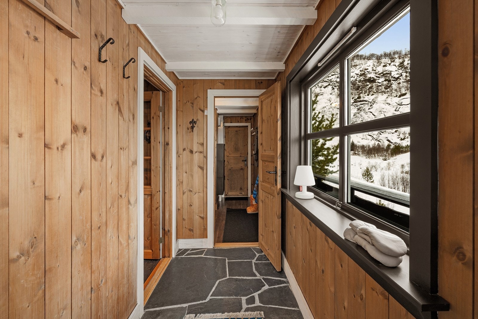 God plass for oppheng og sko, samt enkel tilgang til de ulike avdelingene i hytten. Entre til hovedetasjen med tilgang til hall, samt trapp ned til kjeller. Egen kjellerinngang også. Galleribilde