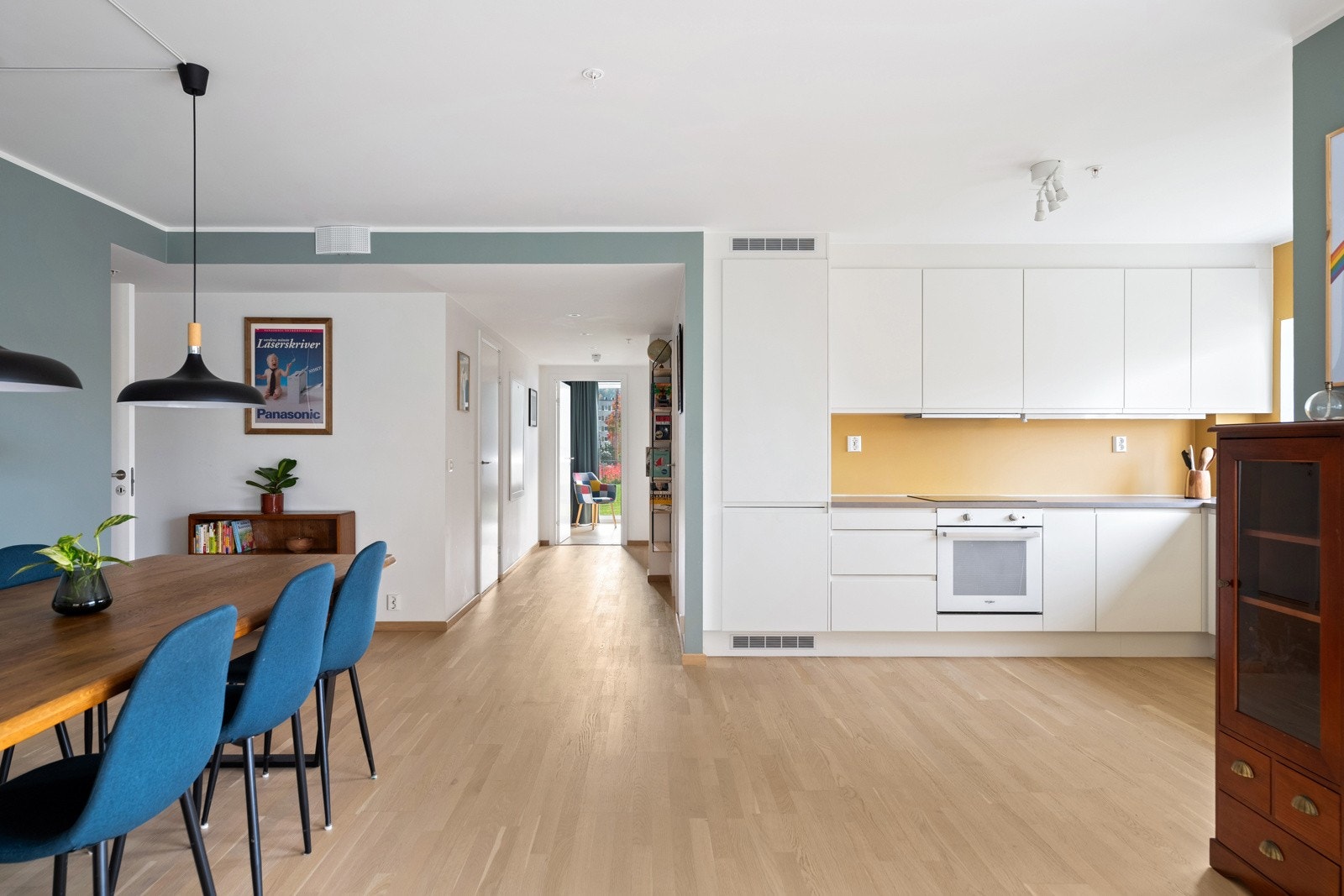 Åpen løsning mellom stue og kjøkken gir en romslig og luftig atmosfære Galleribilde