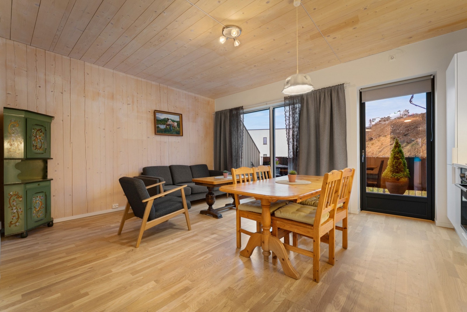 Stuen er lys og luftig med store vindusflater og god plass til sofagruppe Galleribilde