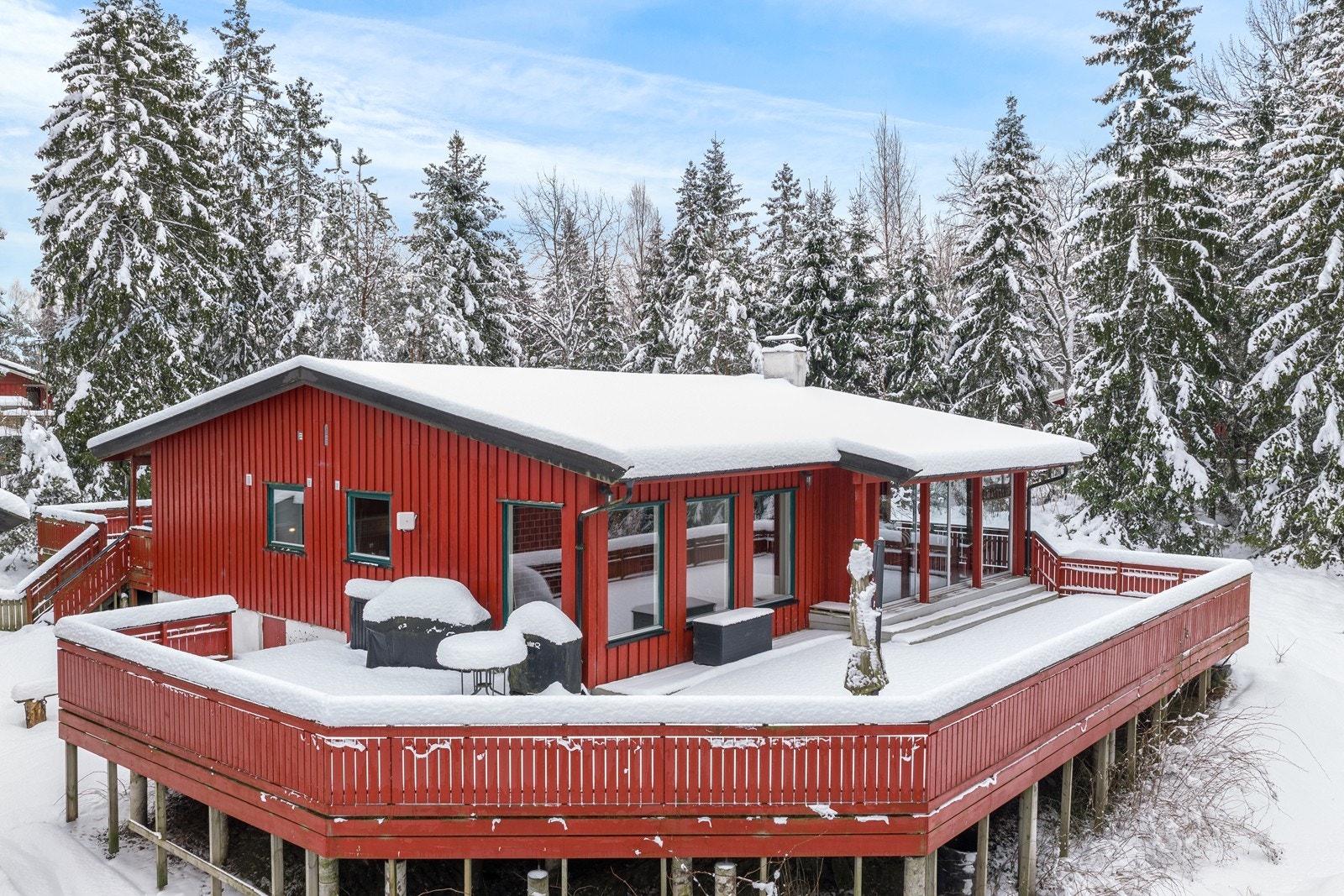En innholdsrik eiendom med enebolig, anneks og garasje, omkranset av skog Galleribilde