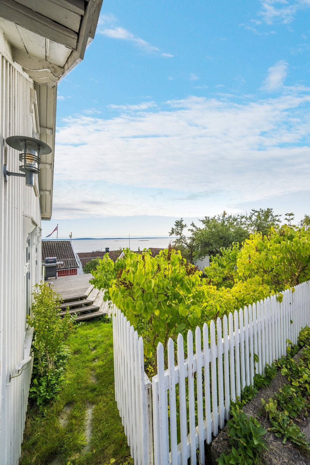 Hvite stakittgjerder og syriner hører med. Galleribilde