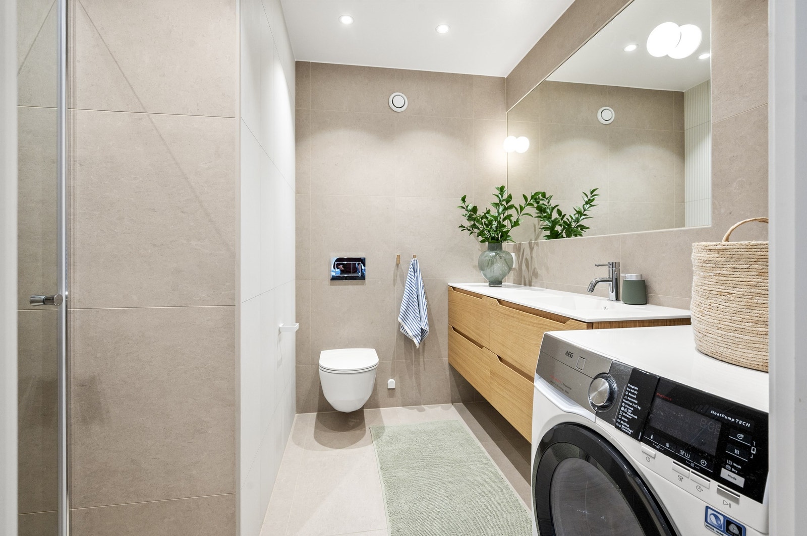 Badet ble utvidet og totalrenovert i 2022 og er elegant flislagt med varme i gulvet for økt komfort. Arbeidet er gjort av fagfolk og all dokumentasjon foreligger. Galleribilde