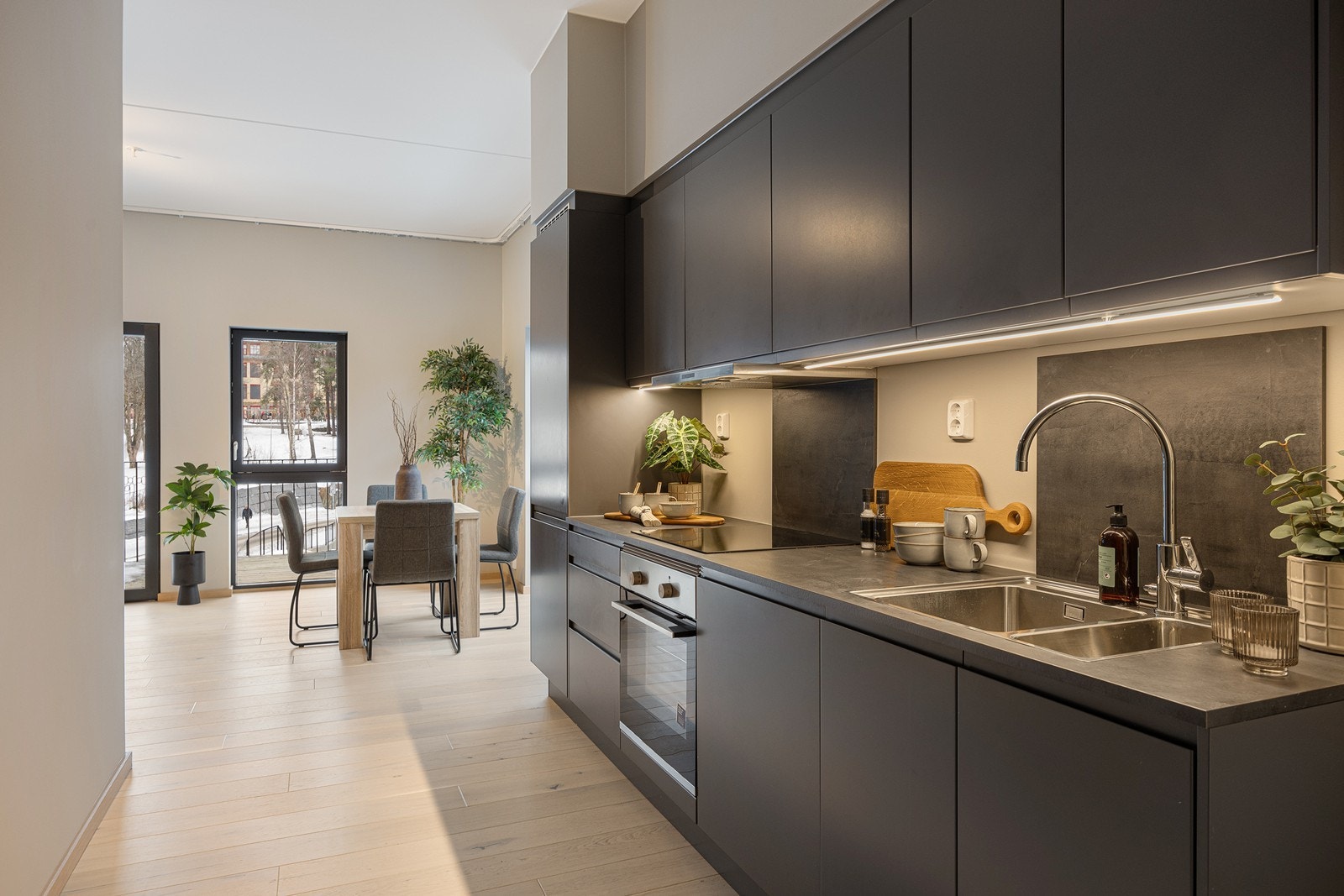 Hvitevarer som kjøl/fryseskap, oppvaskmaskin, nedfelt induksjonstopp og innebygget stekeovn er integrert i innredningen. Galleribilde