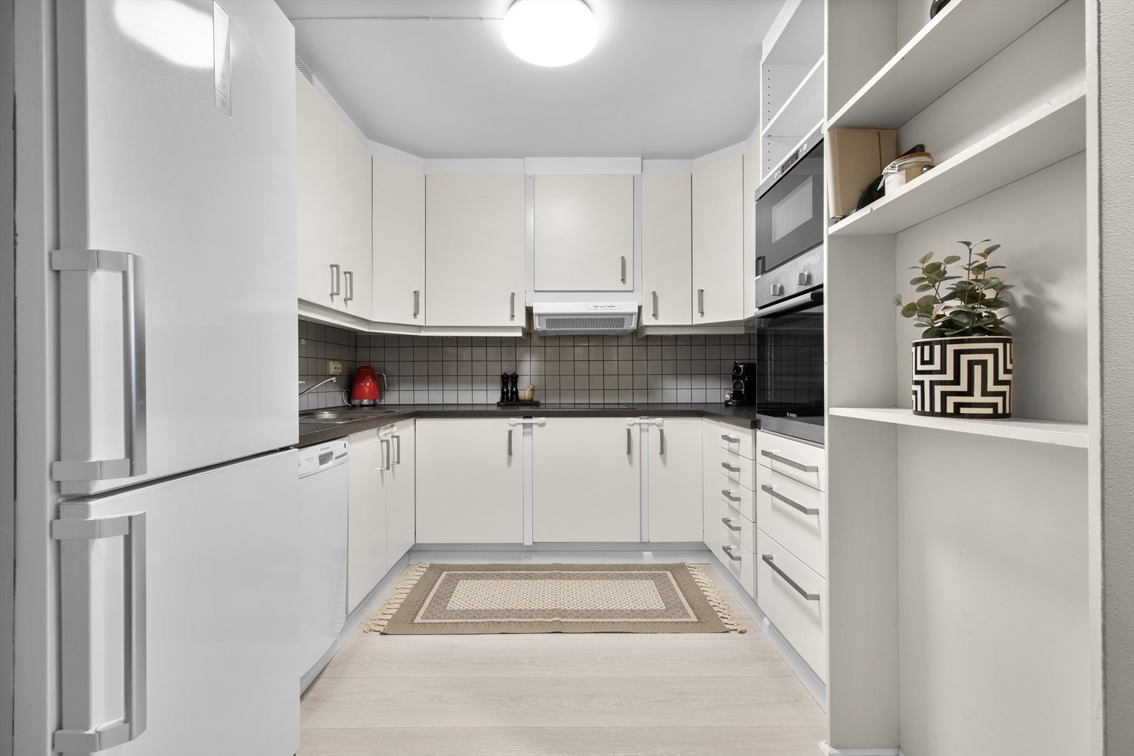 Lyst kjøkken med god skap- og benkeplass. Galleribilde