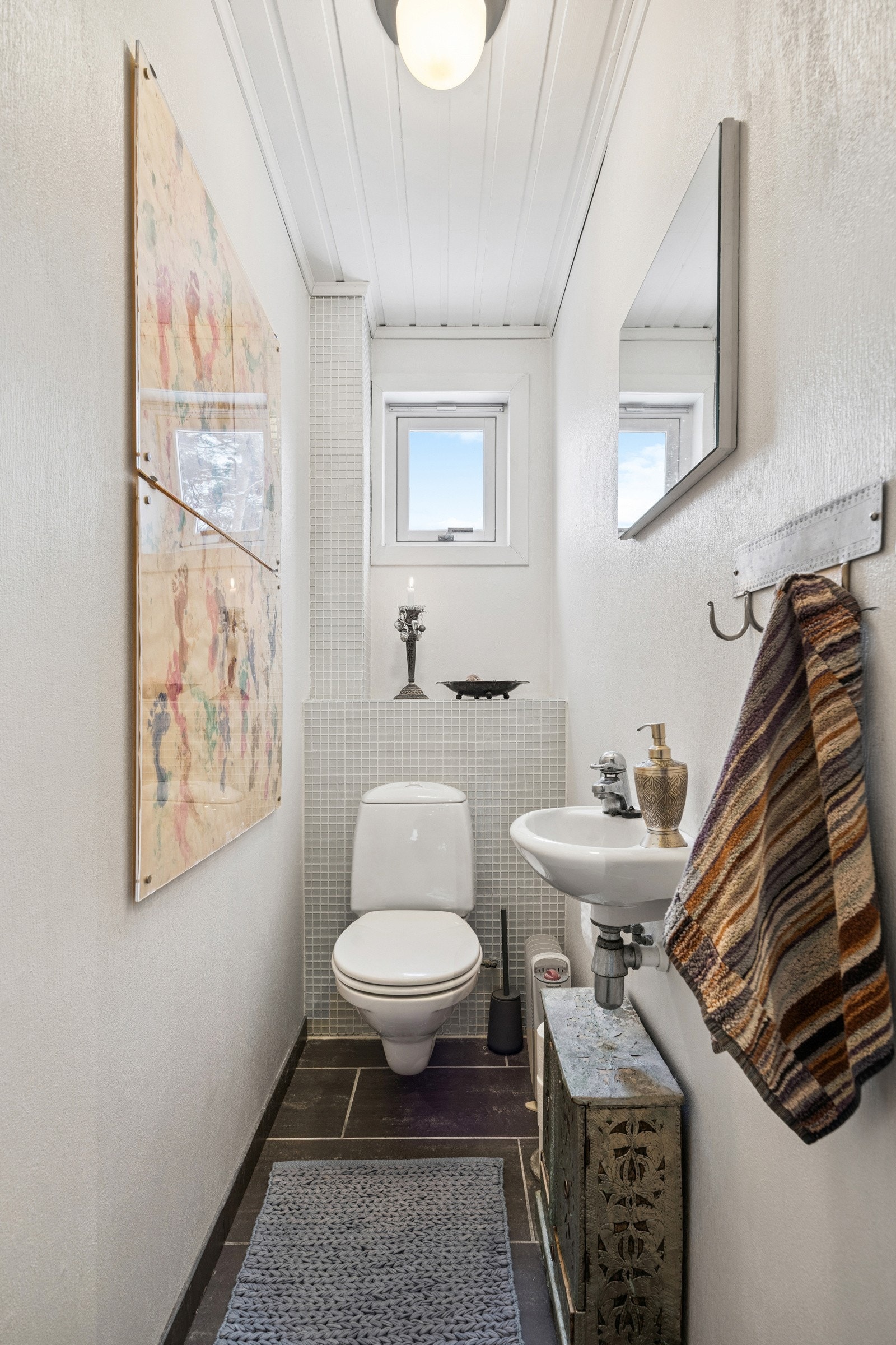 I hovedetasjen finnes et separat toalettrom med flislagt gulv og vegghengt toalett Galleribilde