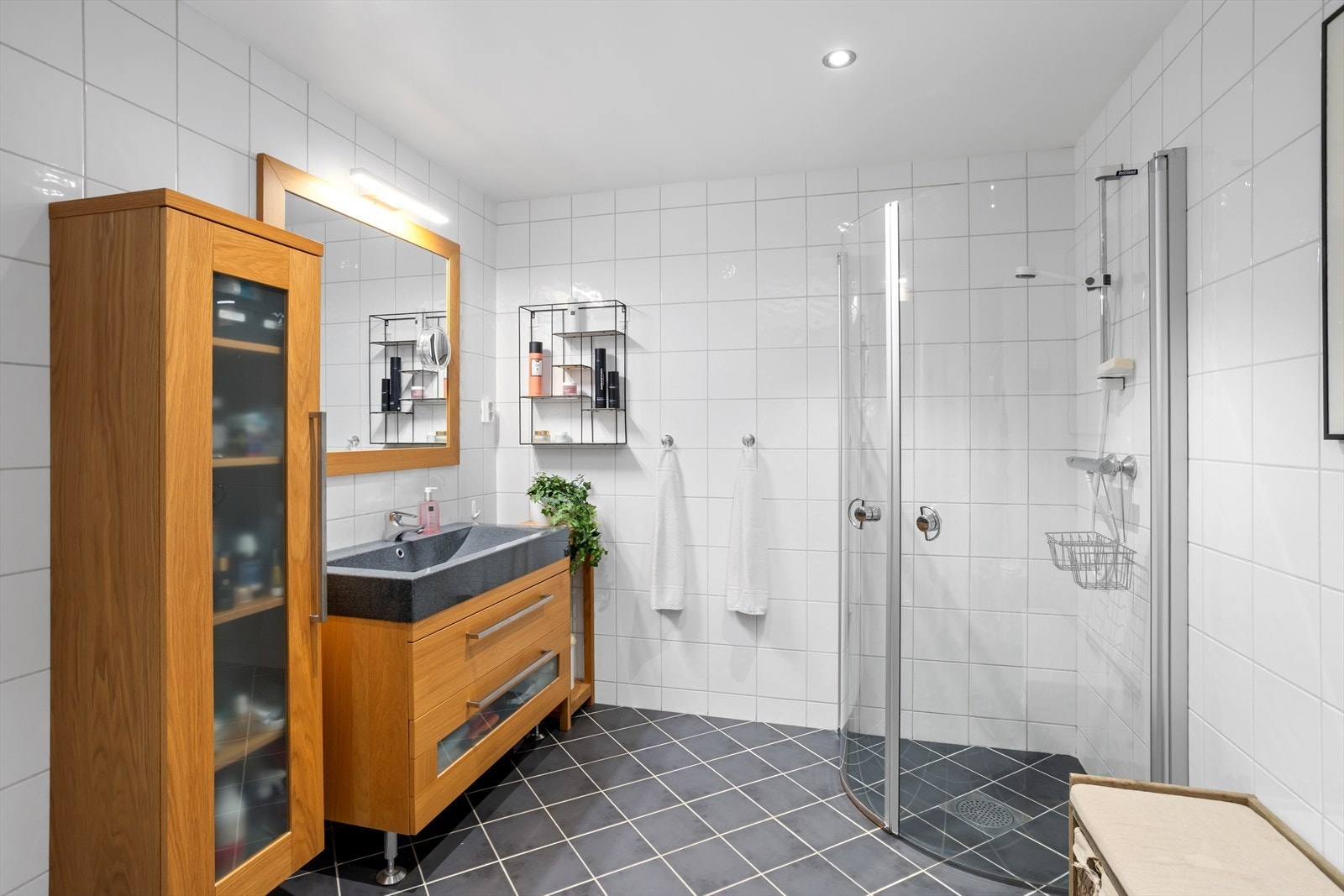 Baderommet har nøytrale fliser på gulv og vegger - også dette har god plass. I entreèn er det skyvedørsgarderobe og leiligheten har både innerbod og kjellerbod. Galleribilde