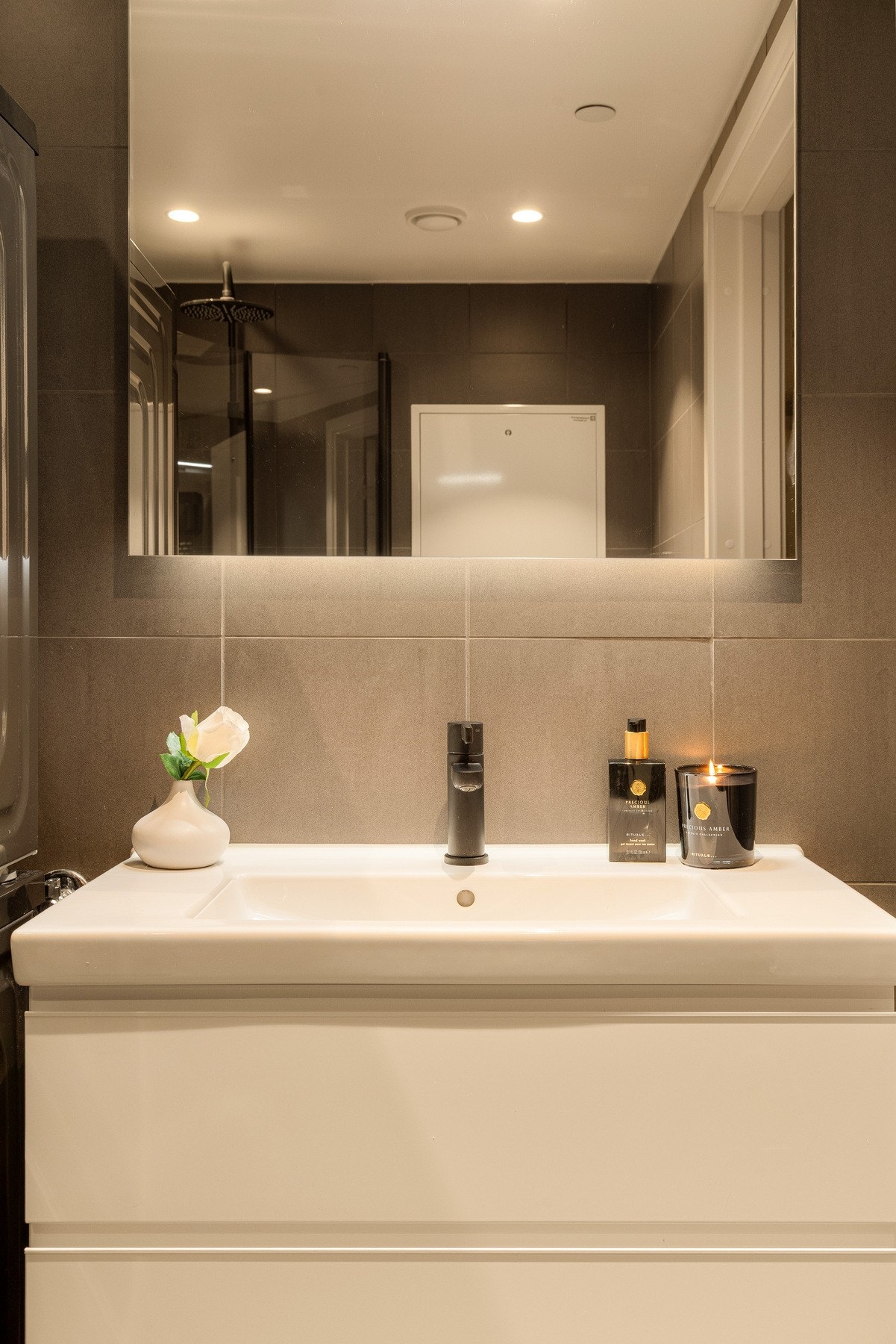 Her finner du et vegghengt servantskap med glatte fronter, nedsenket servant og speil med overbelysning. Galleribilde