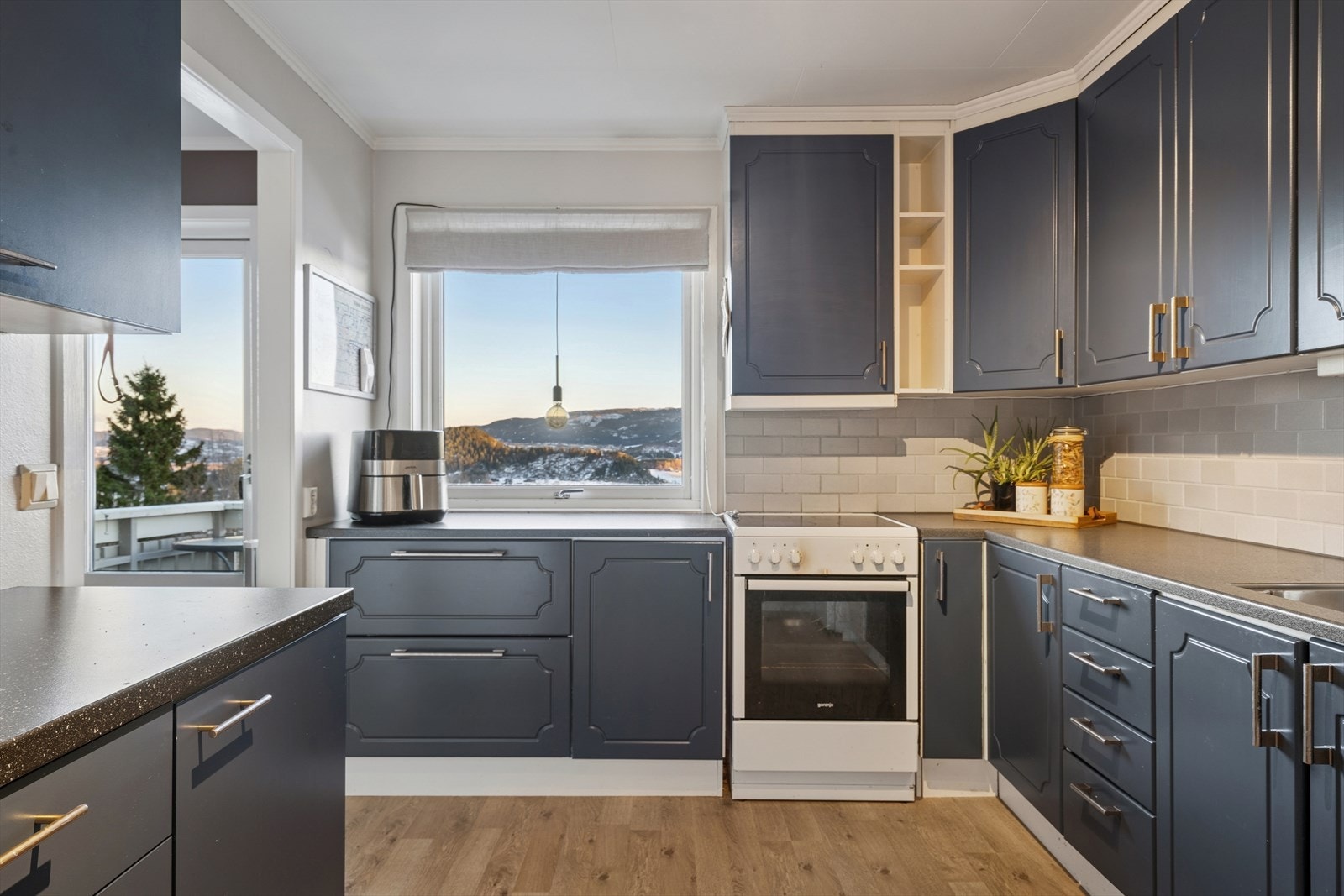 Stilrent kjøkken med mørke fronter og god benkeplass. Galleribilde