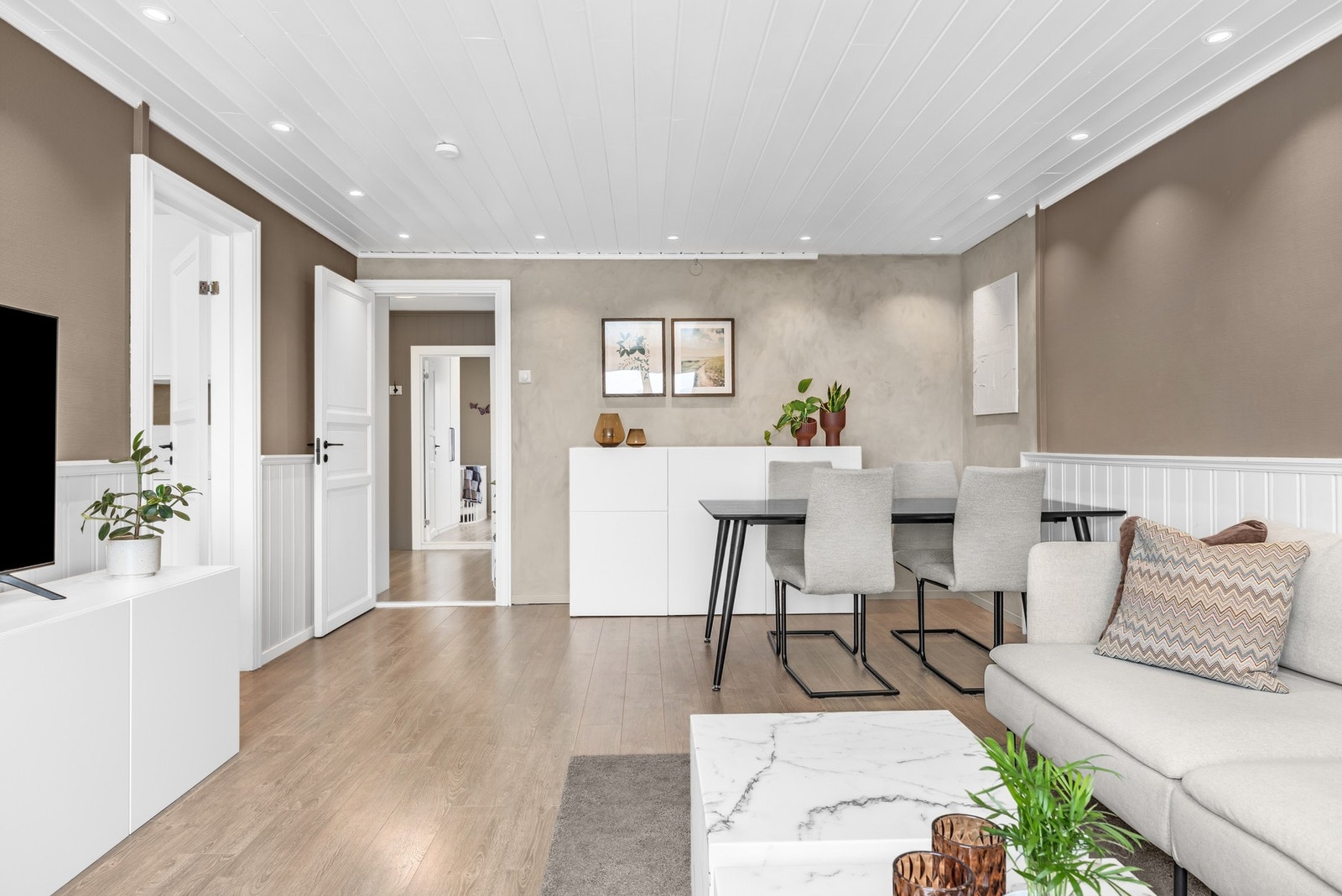 Helhetlig og innbydende oppholdsrom med gjennomgående lyse flater og moderne uttrykk. Galleribilde