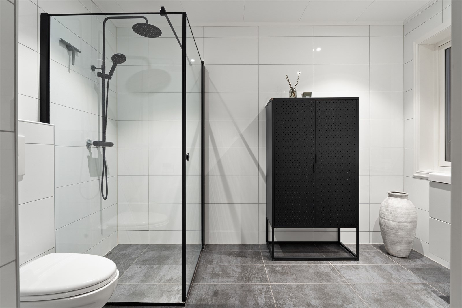 Baderom i andre etasje har dusjhjørne med glassdør og flislagte overflater. Galleribilde