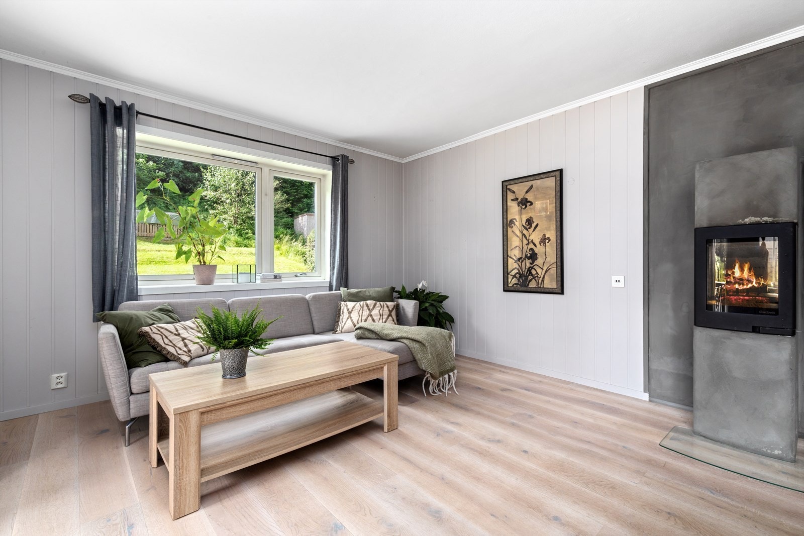 Lys og romslig stue, med moderne peis. Galleribilde