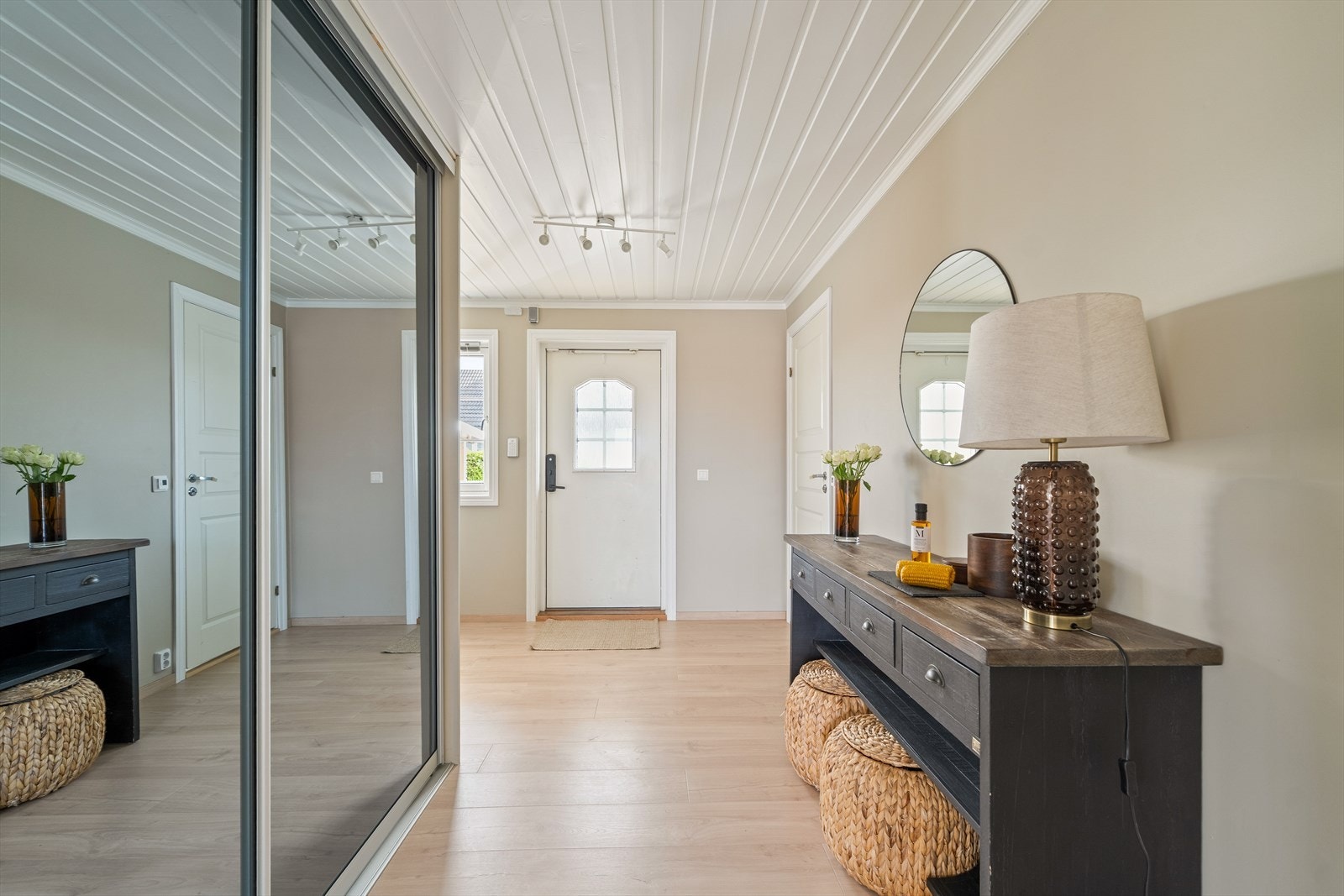 Boligen ønsker velkommen med en lys og romslig entré, malt i en delikat beigetone med hvit himling som gir et tidløst og elegant preg. Galleribilde