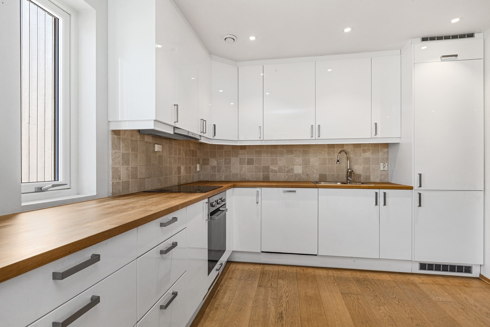 Kjøkkenet har integrerte hvitevarer inkluderende stekeovn, platetopp, kombinert kjøl/fryseskap og oppvaskmaskin. Galleribilde