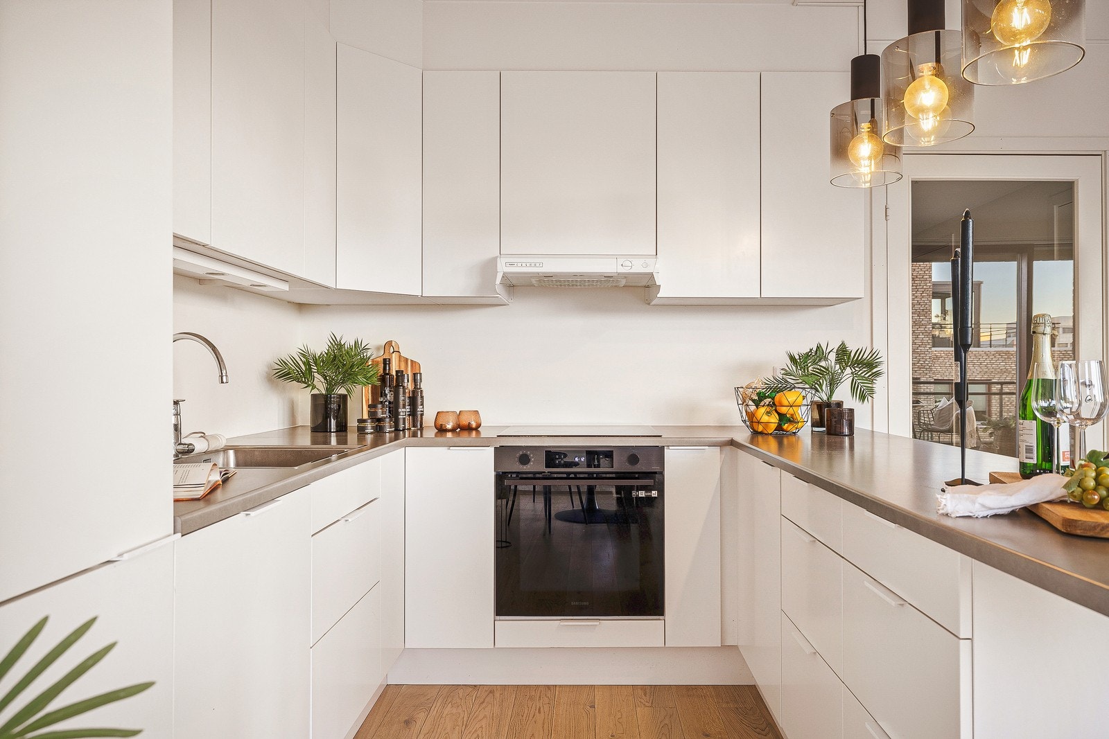 Kjøkkenet har en moderne innredning med glatte fronter og demping på skuffer og skap. Galleribilde