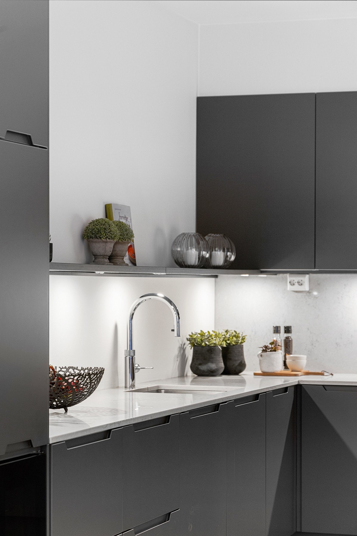 Moderne og oppgradert kjøkkeninnredning fra Sigdal med slette fabrikklakkerte fronter, benkeplate av stein og enkel oppvaskkum. Galleribilde