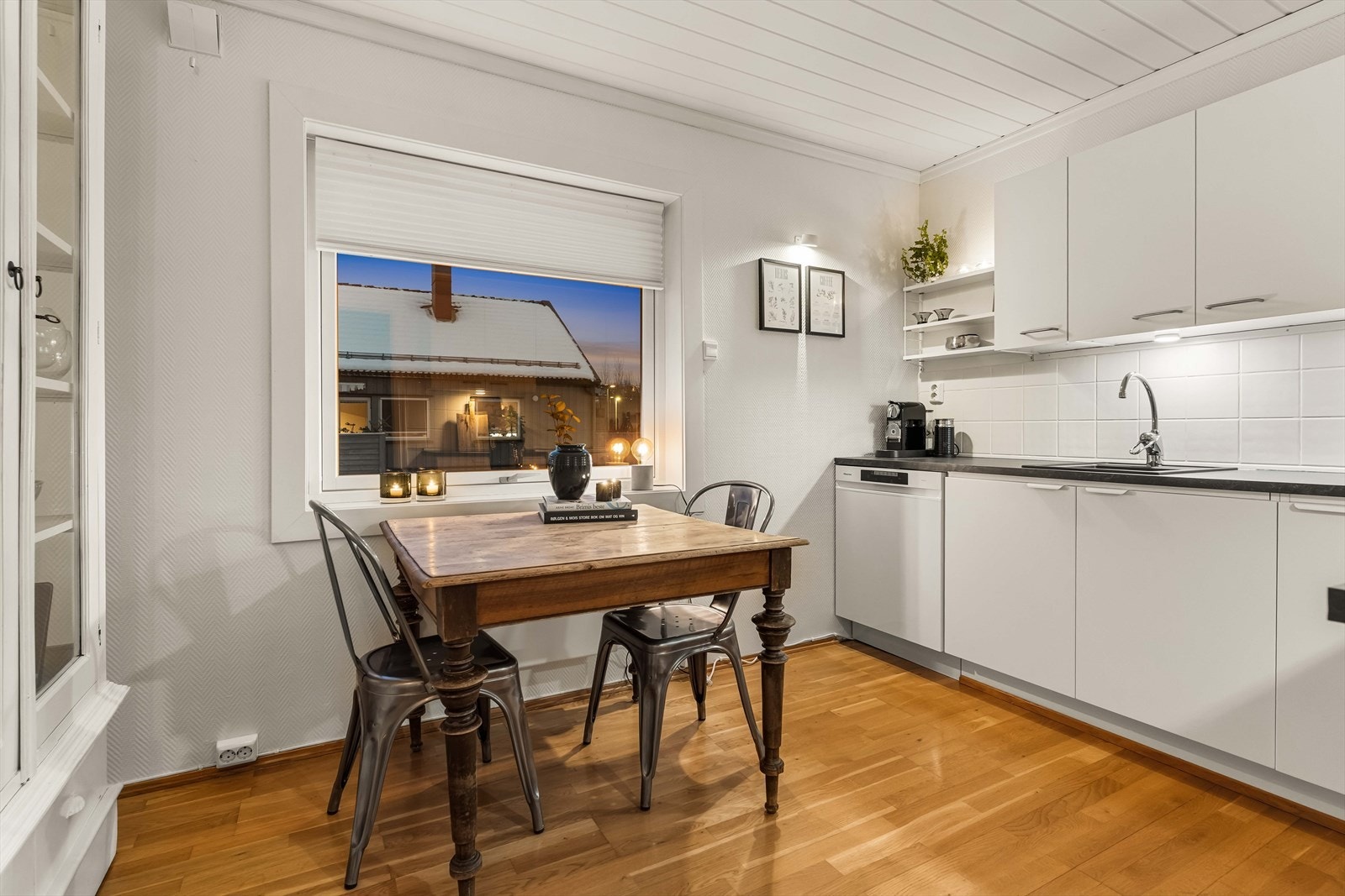 Tidsløs kjøkkeninnredning med glatte fronter, benkeplate i laminat og oppvaskkum i stål. Galleribilde