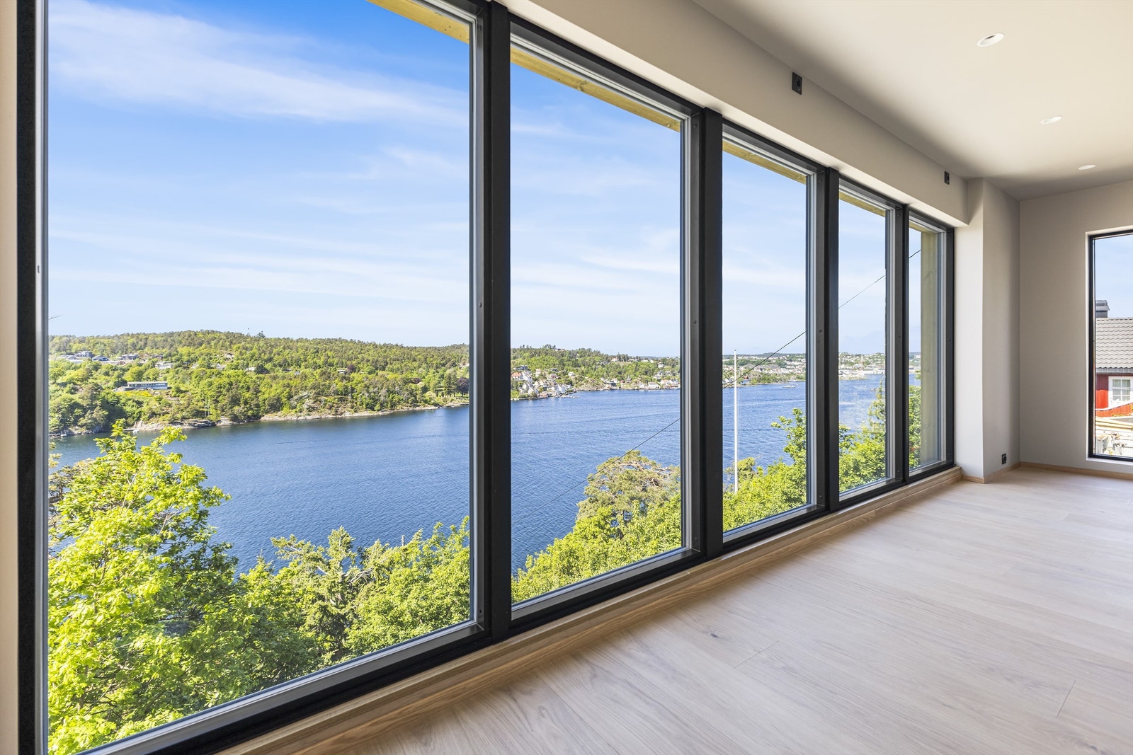 Vindusveggen i stuen slipper naturen inn og sørger for mye naturlig lys Galleribilde