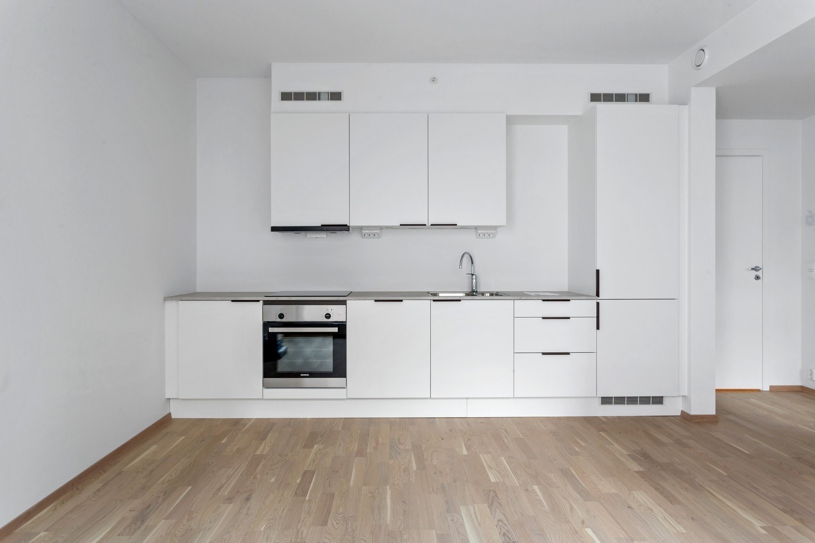 Kjøkkeninnredningen har integrerte hvitevarer som oppvaskmaskin, komfyr, koketopp og kombiskap. Galleribilde